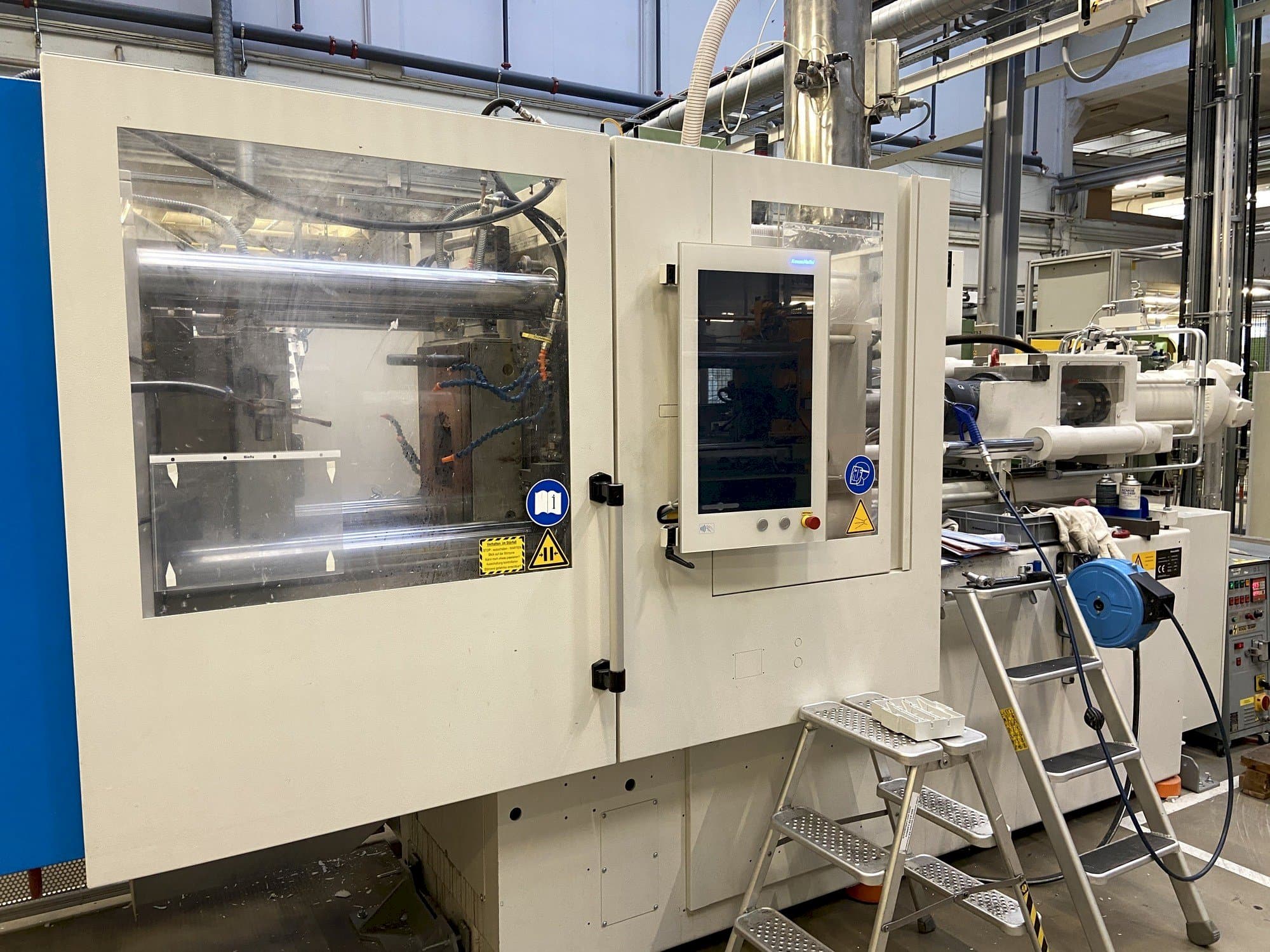 Front view of Krauss Maffei 130-1000 CX DUR machine