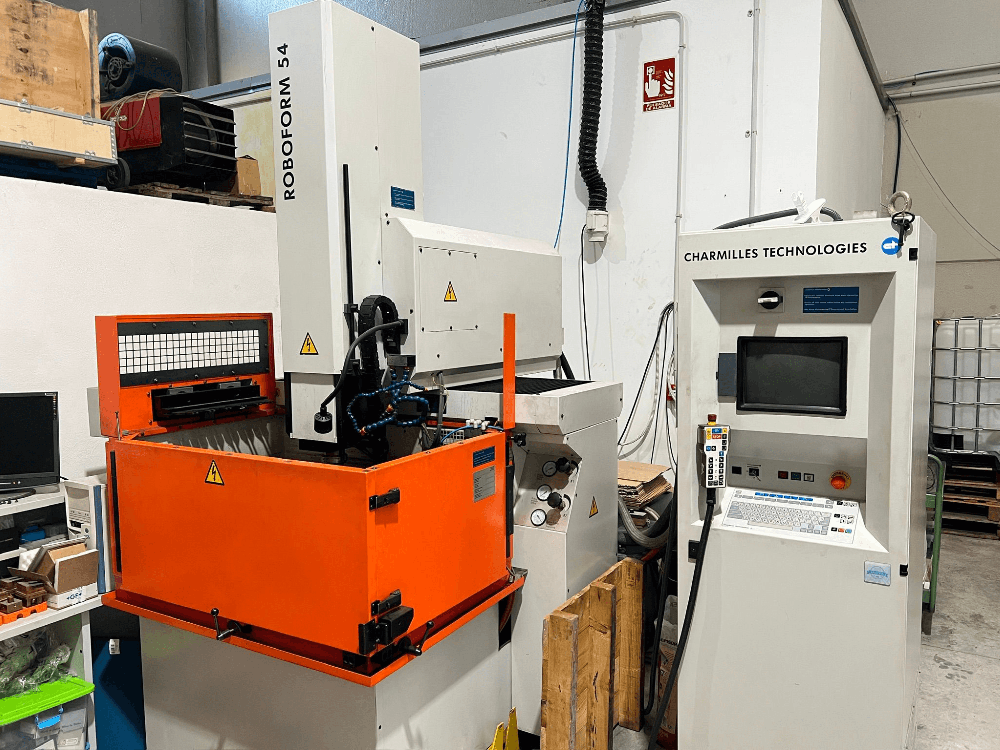 AgieCharmilles Roboform 54 die-sinking EDM machine, front view, featuring orange work tank and control unit.