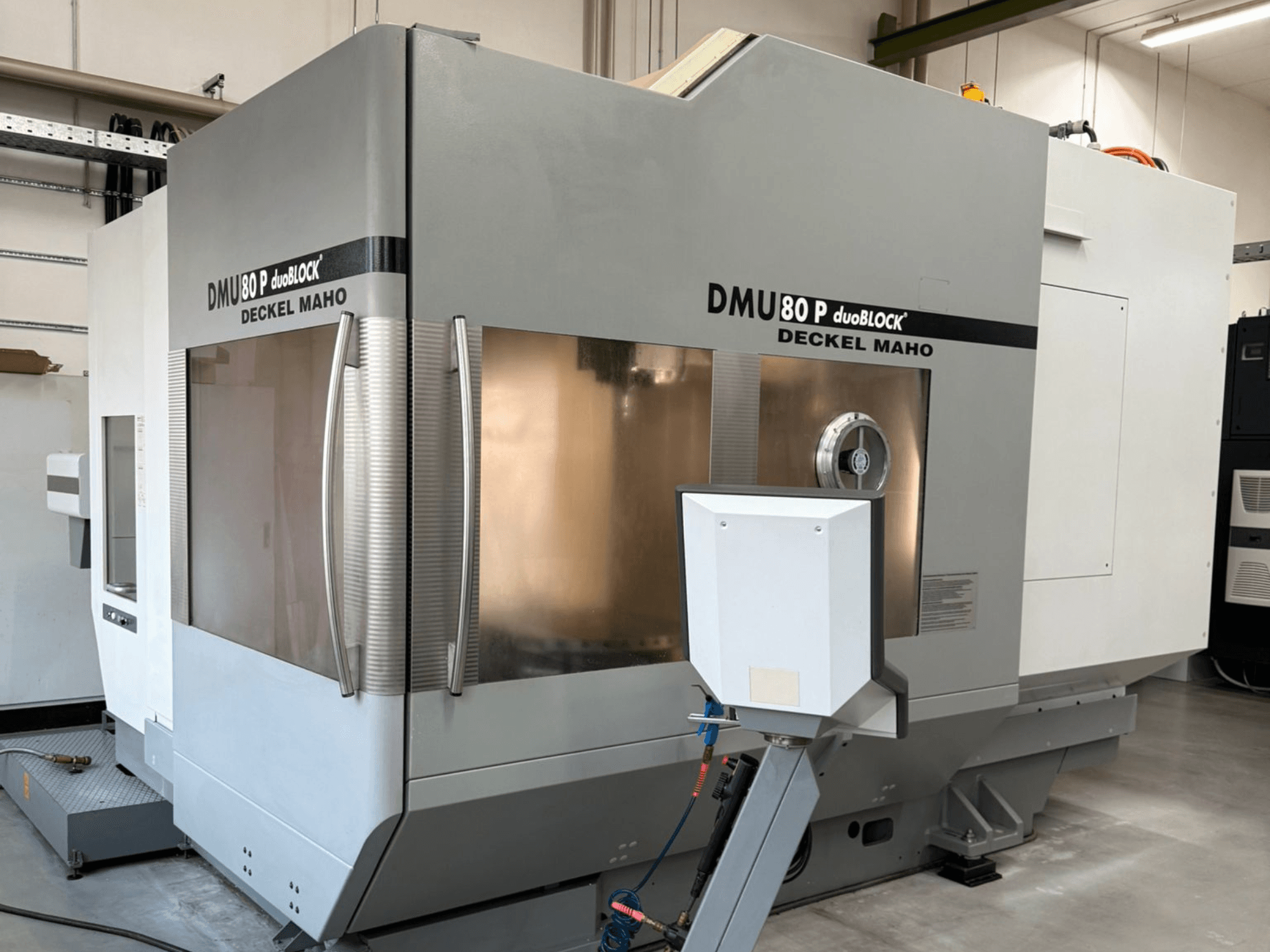 DMU 80 P duoBLOCK by Deckel Maho, front view showing machining center features and control interface in industrial setting.
