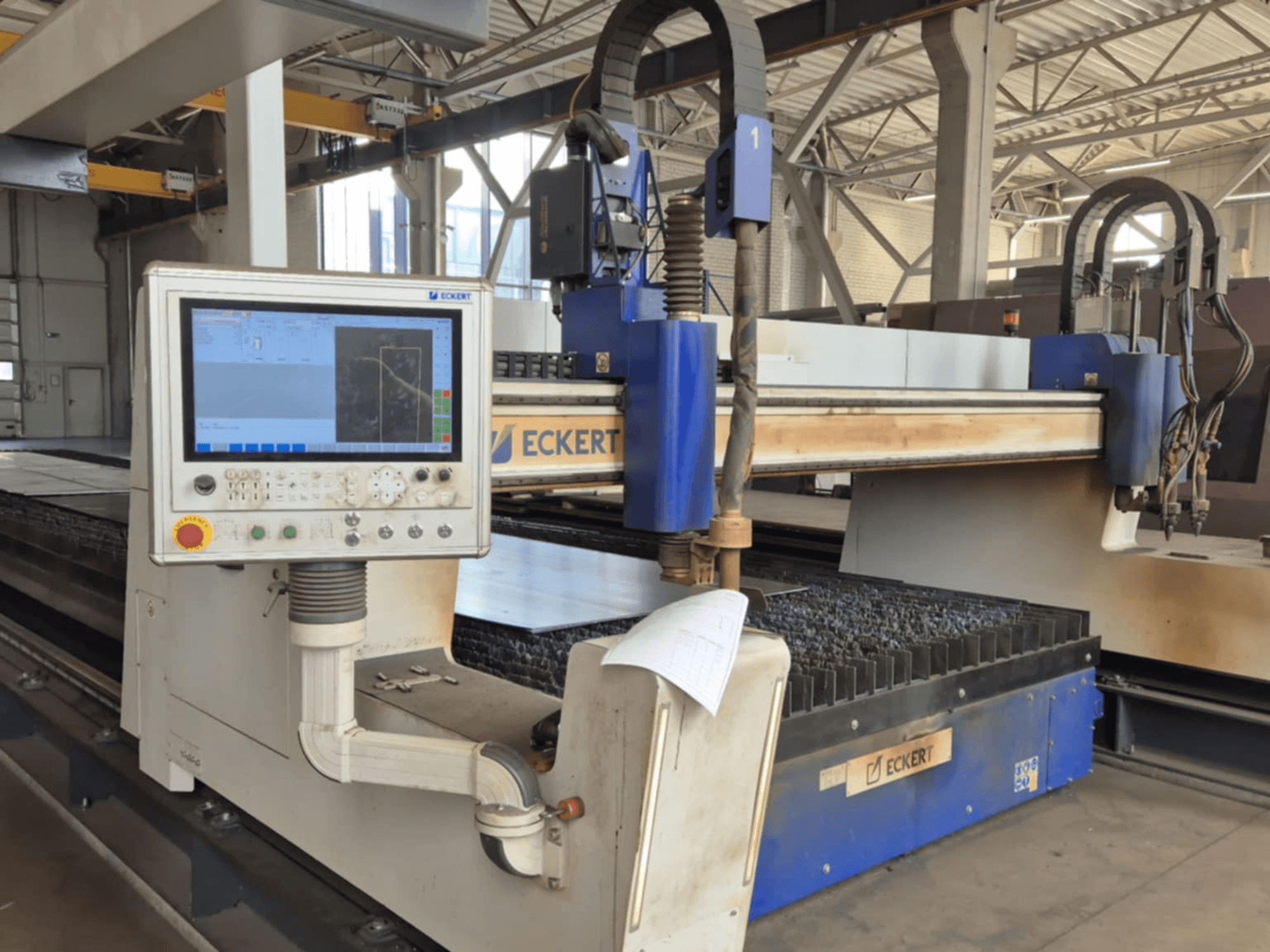 ECKERT CNC cutting machine control panel in front view, featuring a touchscreen display and various operational buttons.