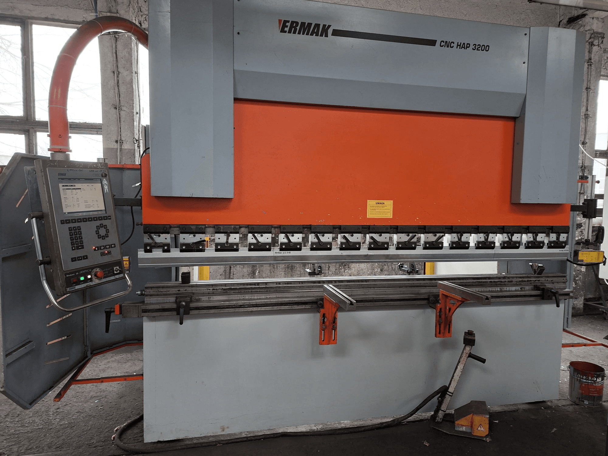 Ermak CNC HAP 3200 press brake, front view, features orange and gray body, control panel with digital display, and adjustable clamps.