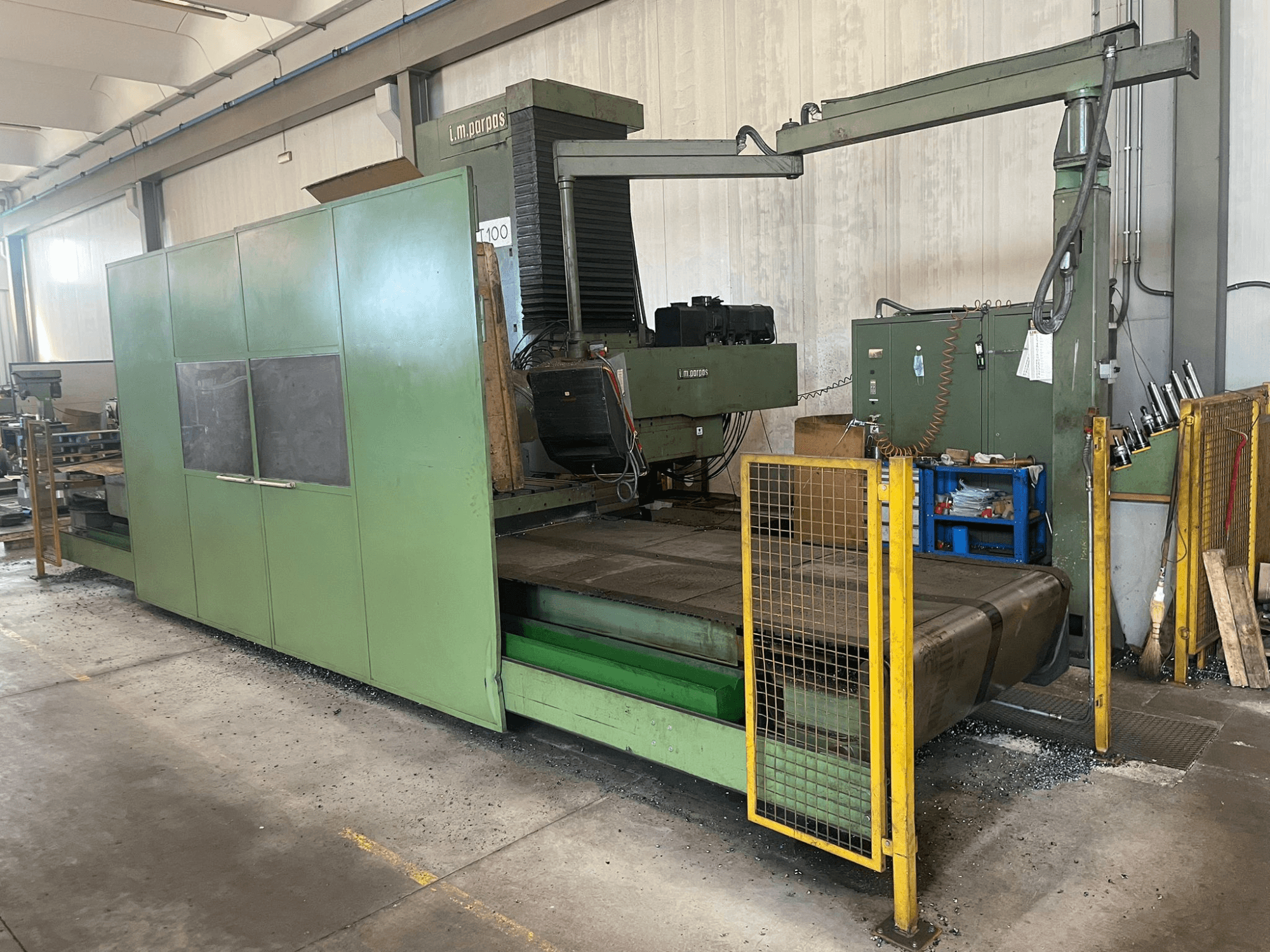 Large green industrial milling machine with safety barriers, front view, featuring model label "l.m. parpas" and visible controls.