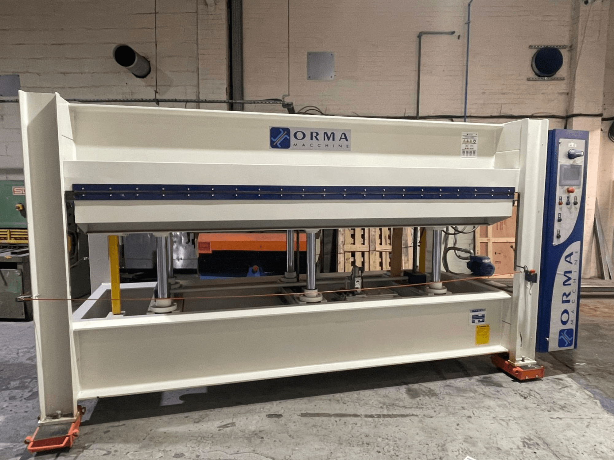 ORMA machinery hydraulic press, front view, with silver finish, control panel on the right, and upright pistons for pressing.