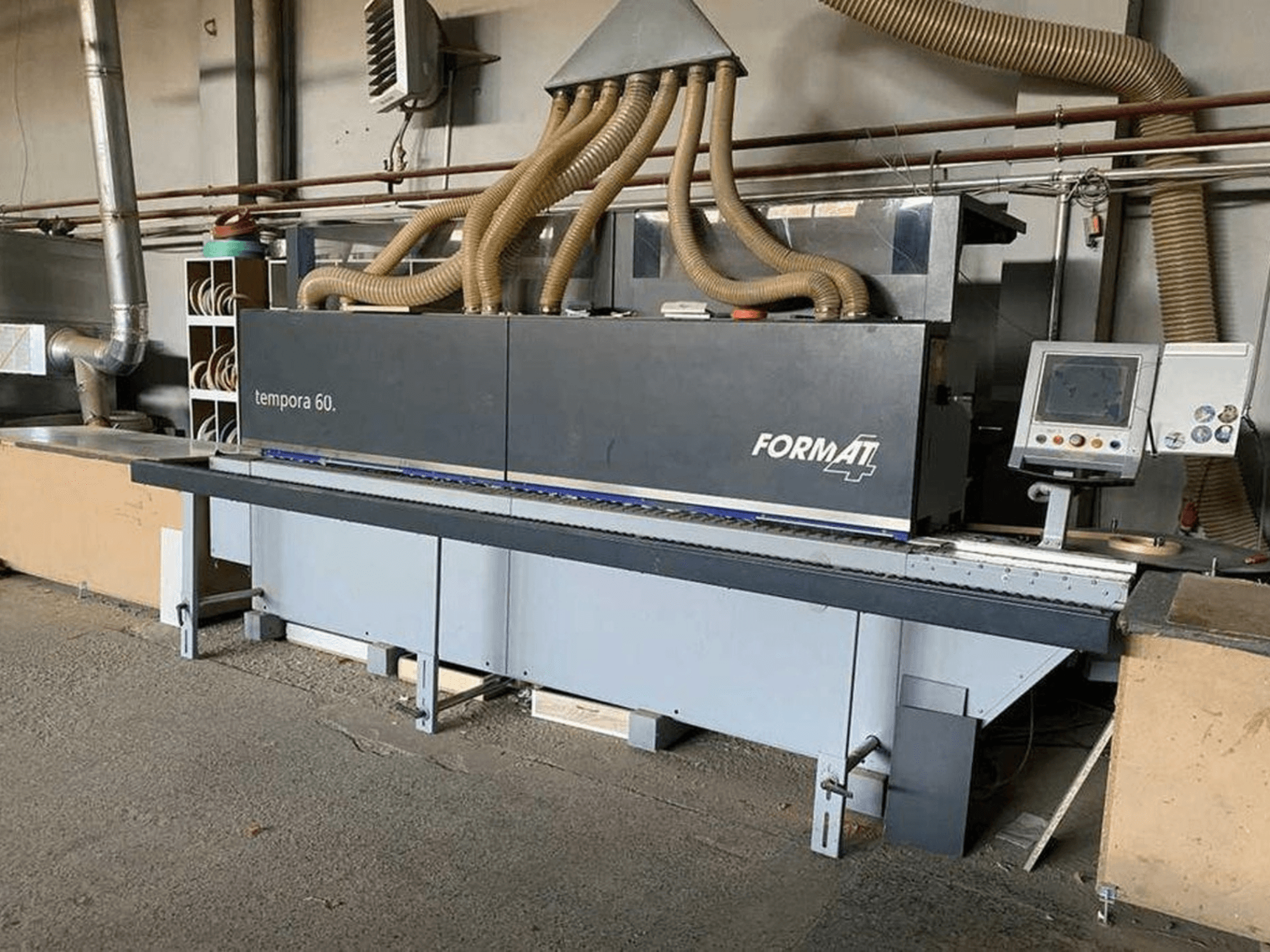 FORMAT4 Tempora 60 edgebanding machine in side view, featuring multiple hoses and a control panel with buttons and screen.