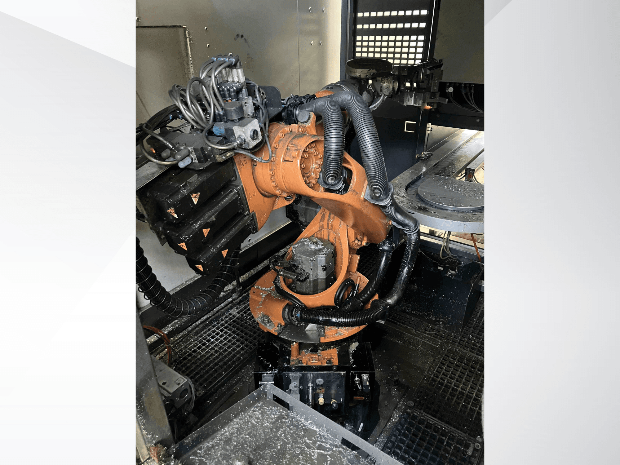 KUKA KR 16 robot arm viewed from a top angle, showcasing mechanical components and wiring in a workshop environment.