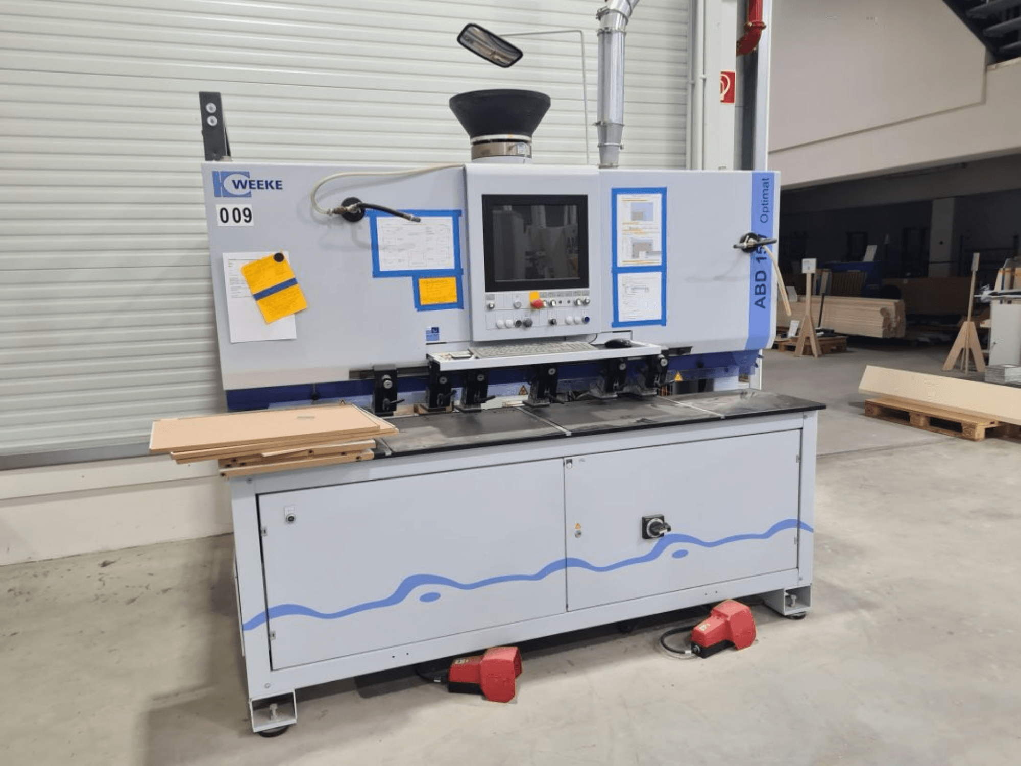 HOMAG WEEKE OPTIMAT ABD150 multi-spindle drilling machine, front view, showing controls and stacked wood panels.