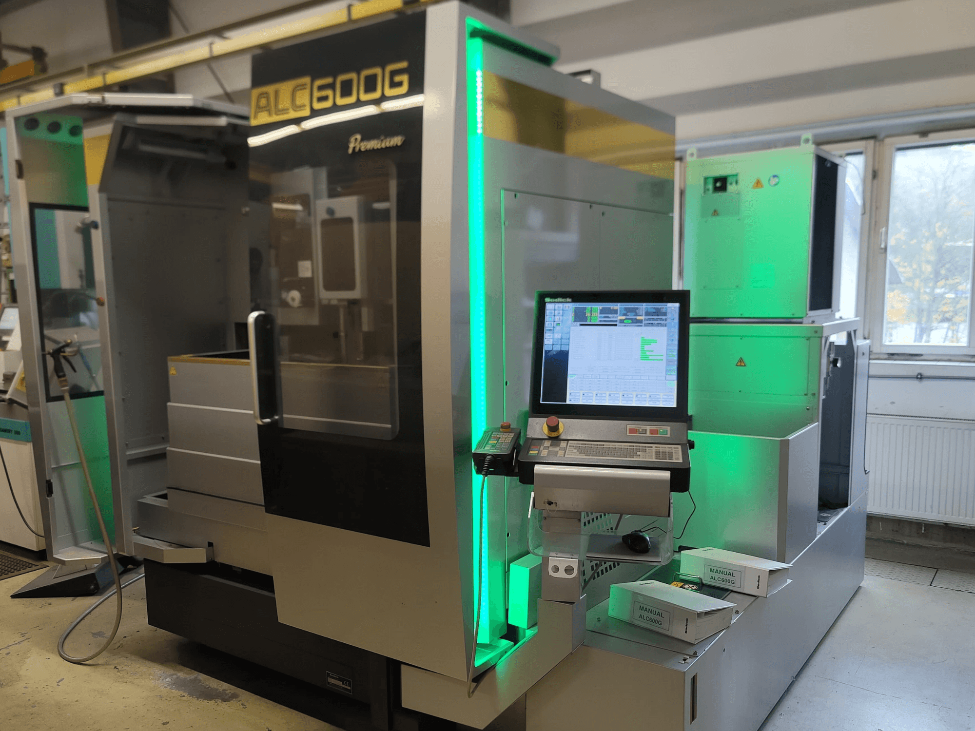 Sodick ALC600G Premium Wire EDM machine, front view, showcasing control panel and illuminated exterior details.