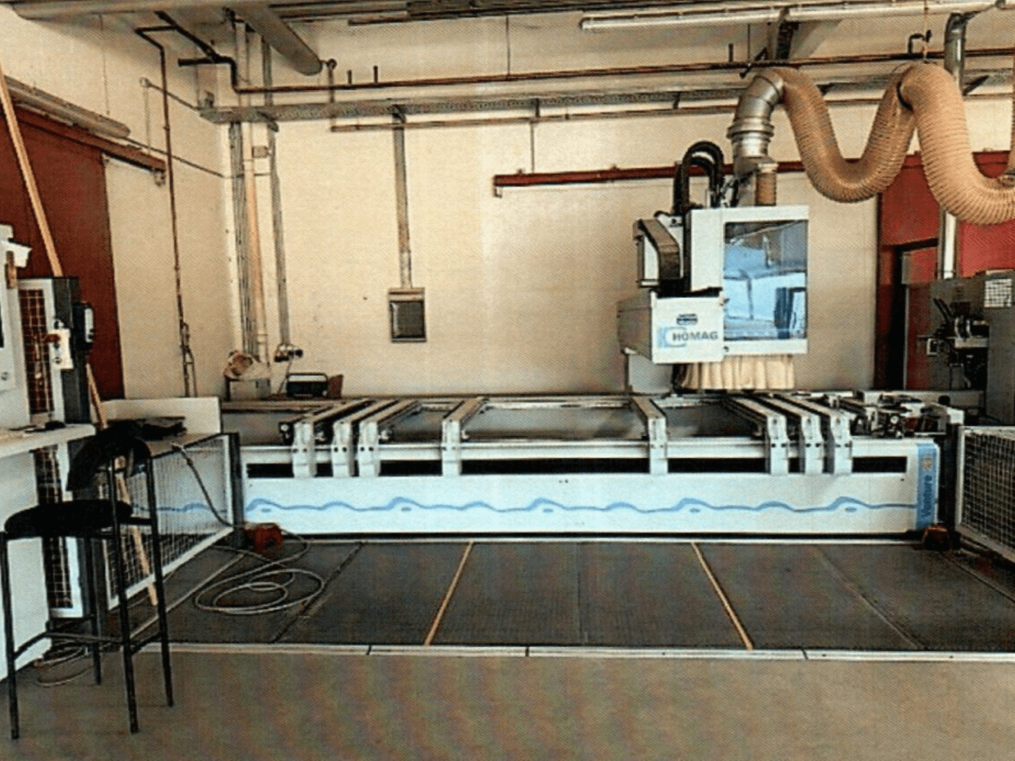 HOMAG BAZ 211/40K CNC wood machining centre in a workshop, showcasing the machine's control panel and cutting area.