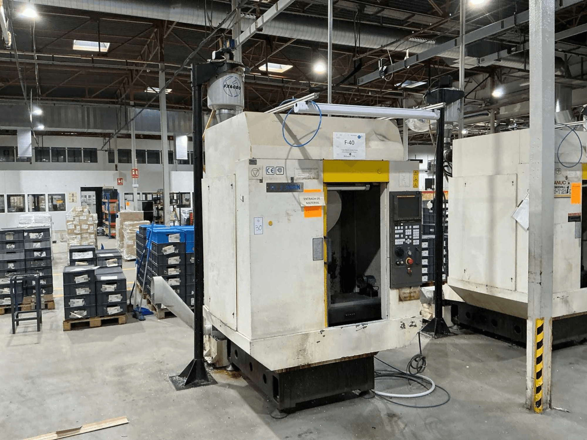 FANUC ROBODRILL α-T21iD, front view of vertical machining center in an industrial setting, with control panel details visible.