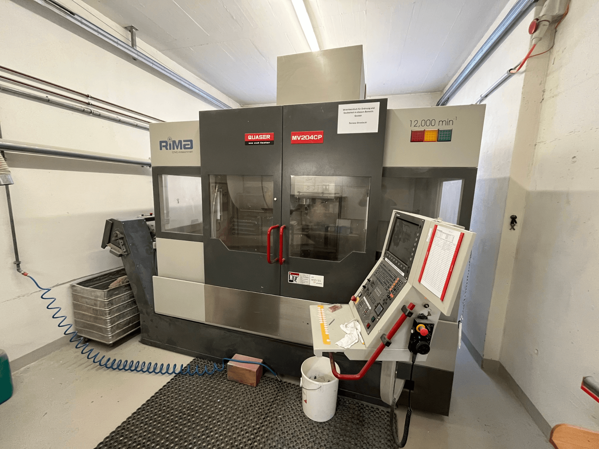 Quaser MV-204 CP vertical machining centre from a front view, displaying control panel and operational details.