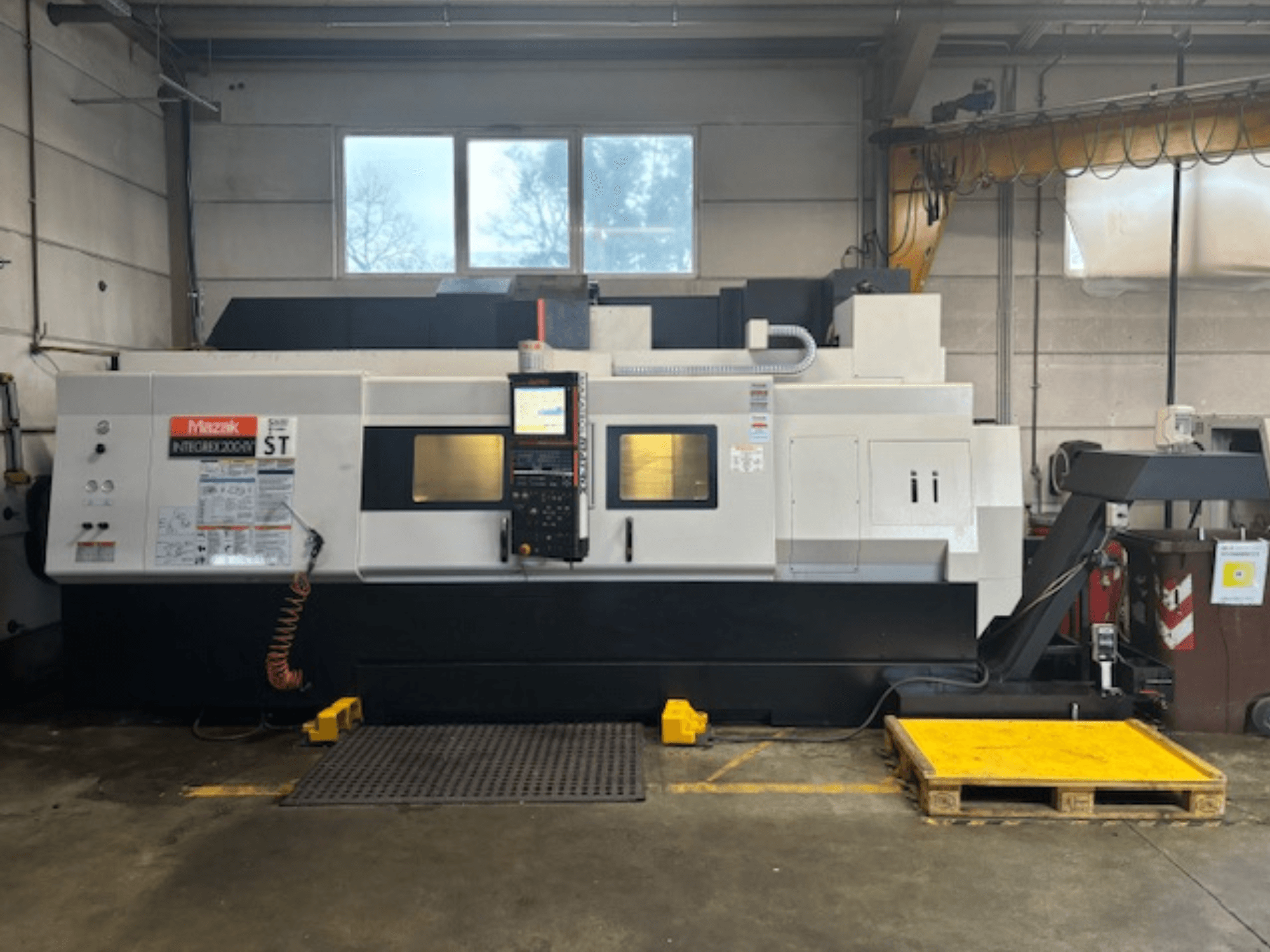 Mazak Integrex 200 SY ST, side view, showing control panel, operation displays, and coolant lines in a workshop setting.