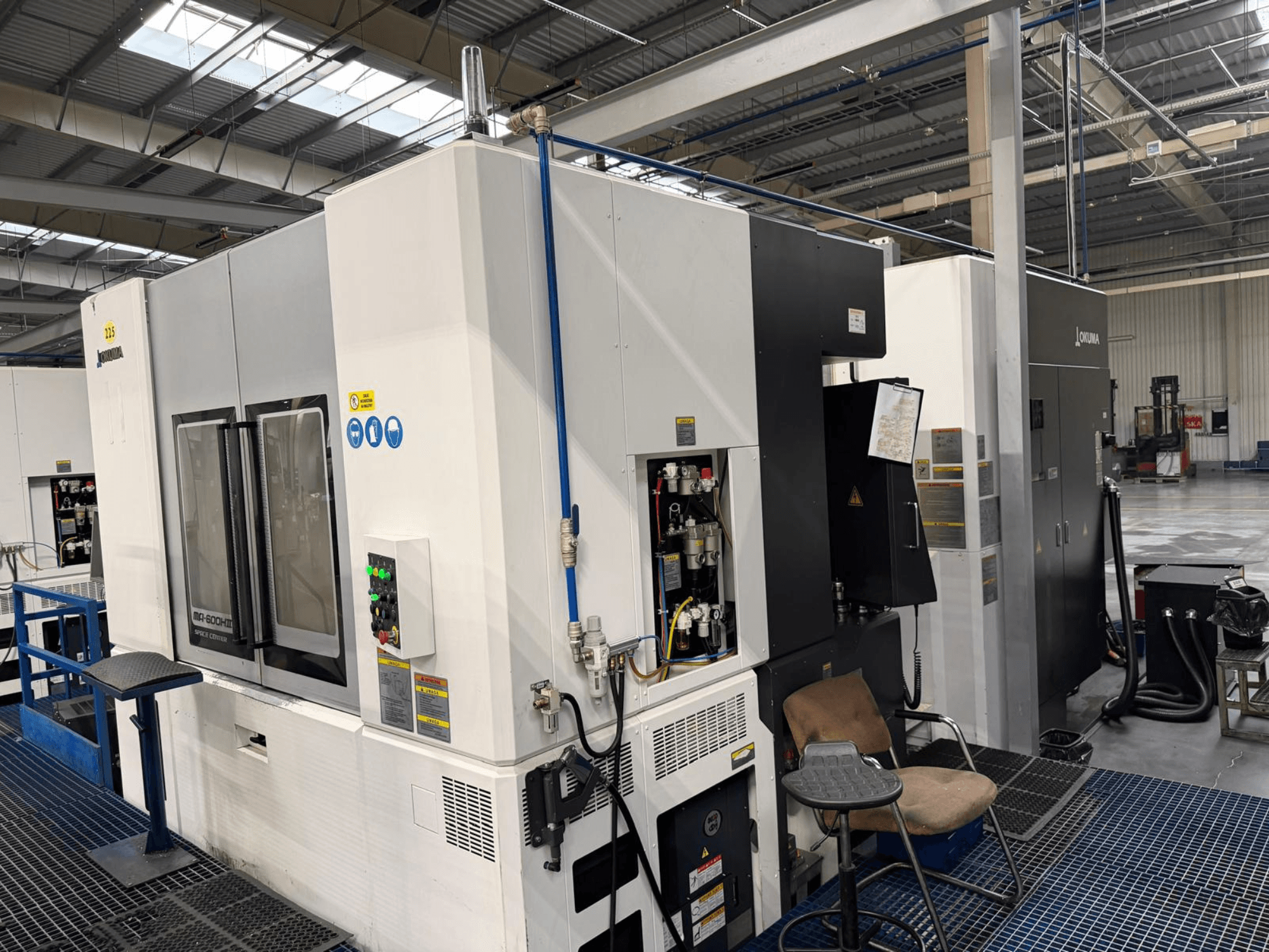 Okuma MA 600H II horizontal machining center, front view, featuring control panel and operational indicators.