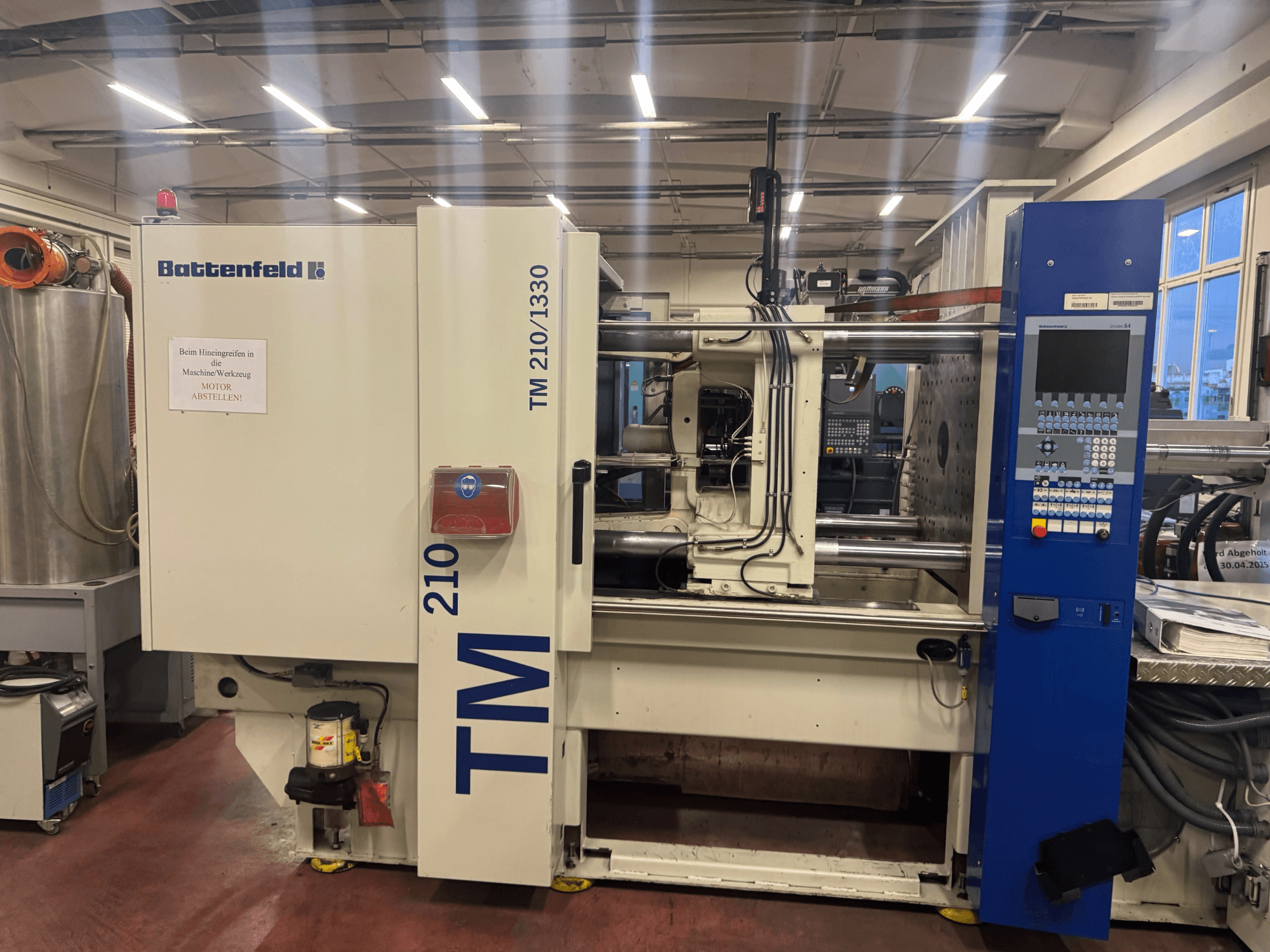 Battenfeld TM 210/1330 hydraulic injection moulding machine, front view, showing control panel and machine components.