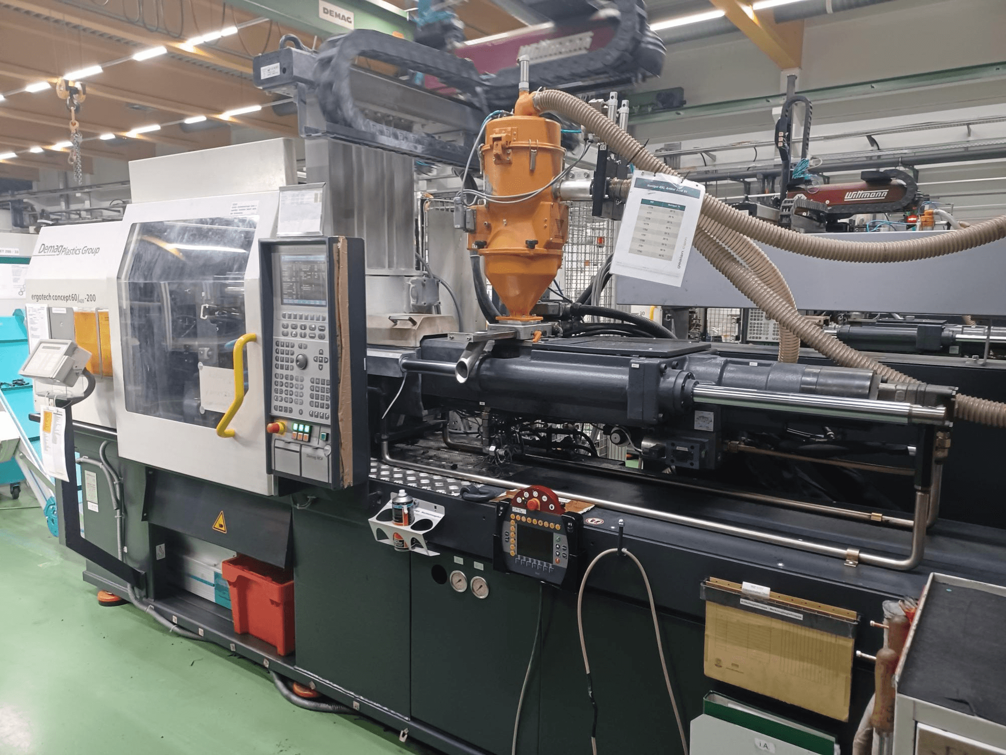 Demag Ergotech 200 injection molding machine, front view, with control panel, nozzle, and operational components visible.