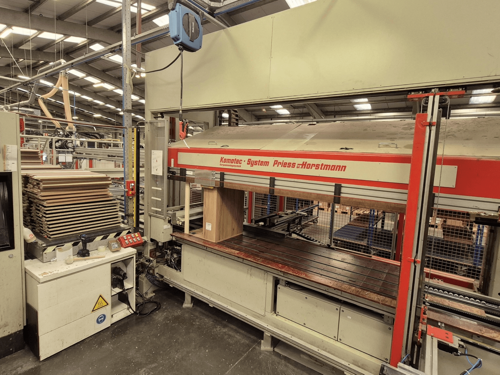 Veneer press KP-5-CNC by PREISS U HORTSTMANN, front view, showcasing stacked veneer sheets and control panel.