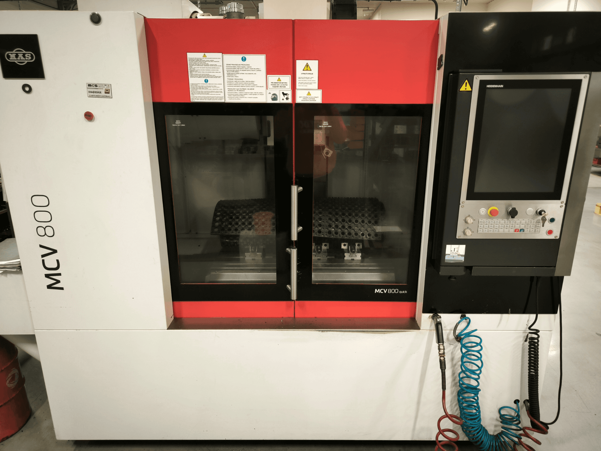 Vertical machining center KOVOSVIT MAS MCV 800 QUICK, front view with control panel and dual glass doors showcasing workspace.