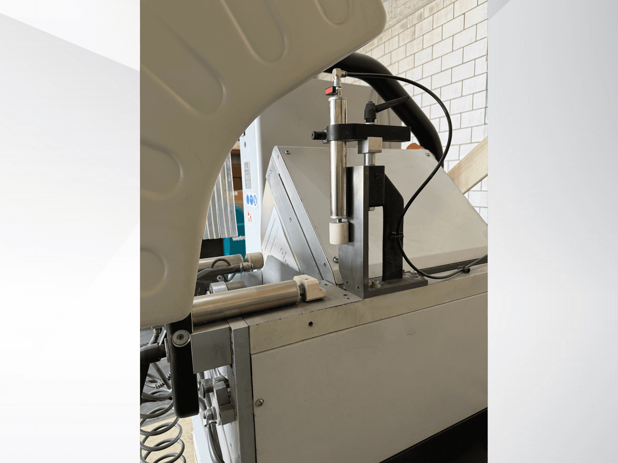 Close-up of a precision dispensing machine with a vertical syringe, visible brand logo, and control panel at front view.