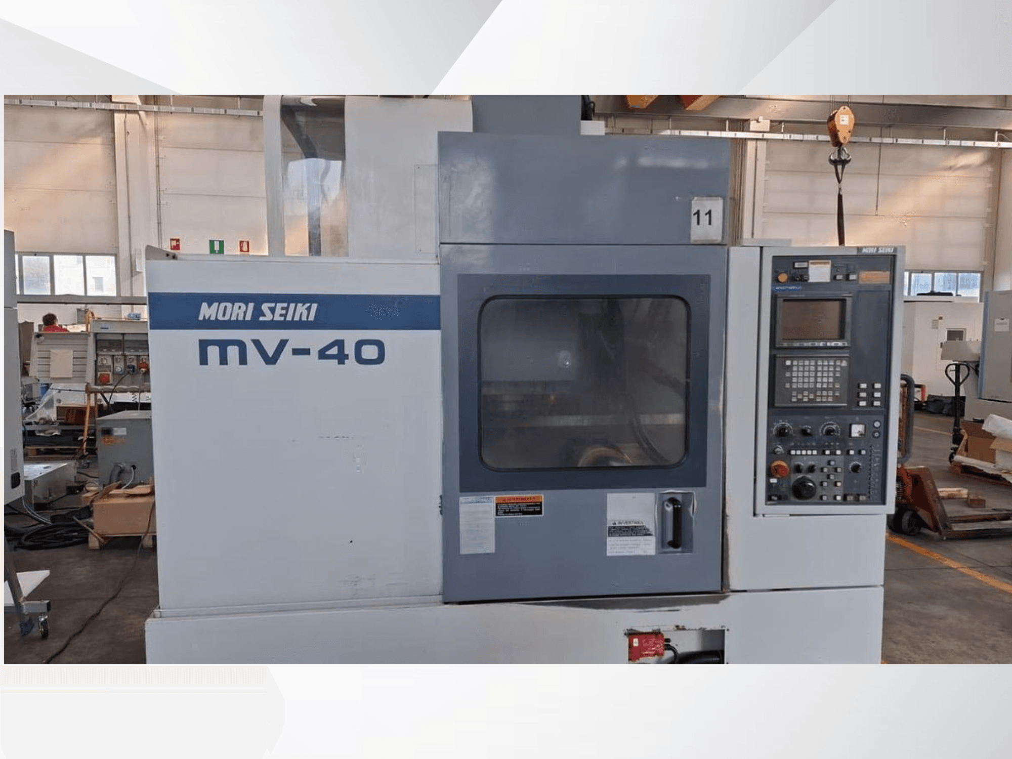 MORI SEIKI MV-40 Vertical Machining Centre, front view showing control panel and window, in a workshop setting.