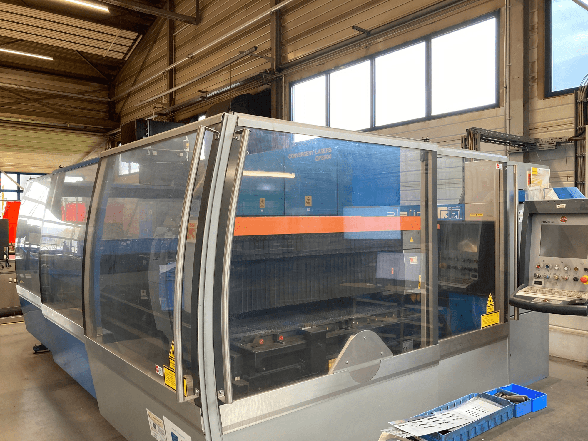 Prima Industrie Platino 1530 CO2 laser cutting machine, front view, with control panel and safety features visible.