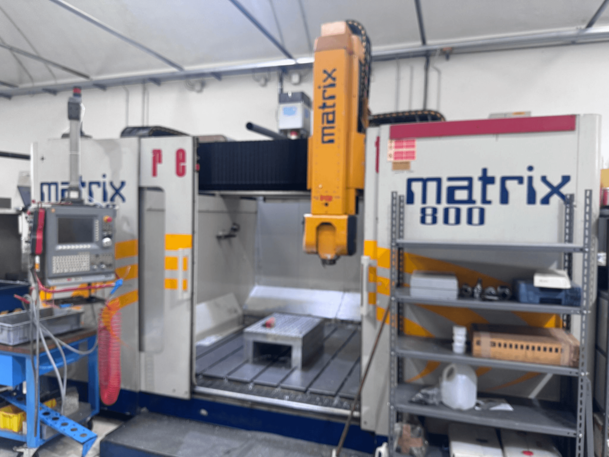 Matrix 800 CNC machine in a workshop view, featuring control panel, tools, and work table with various objects.