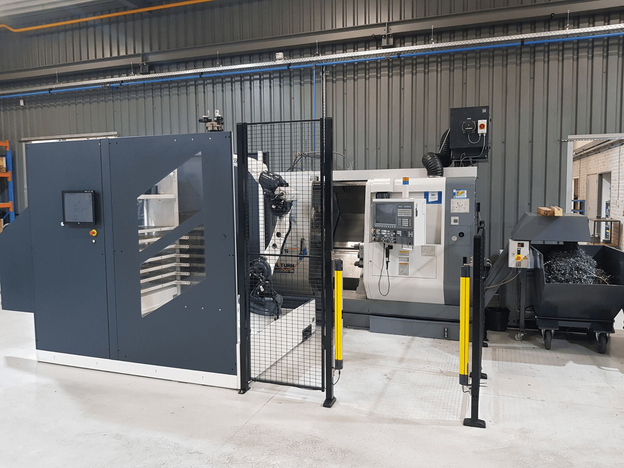 ALTURN automated lathe and CNC machine shown in a factory setting; front view with control panel and safety fencing visible.