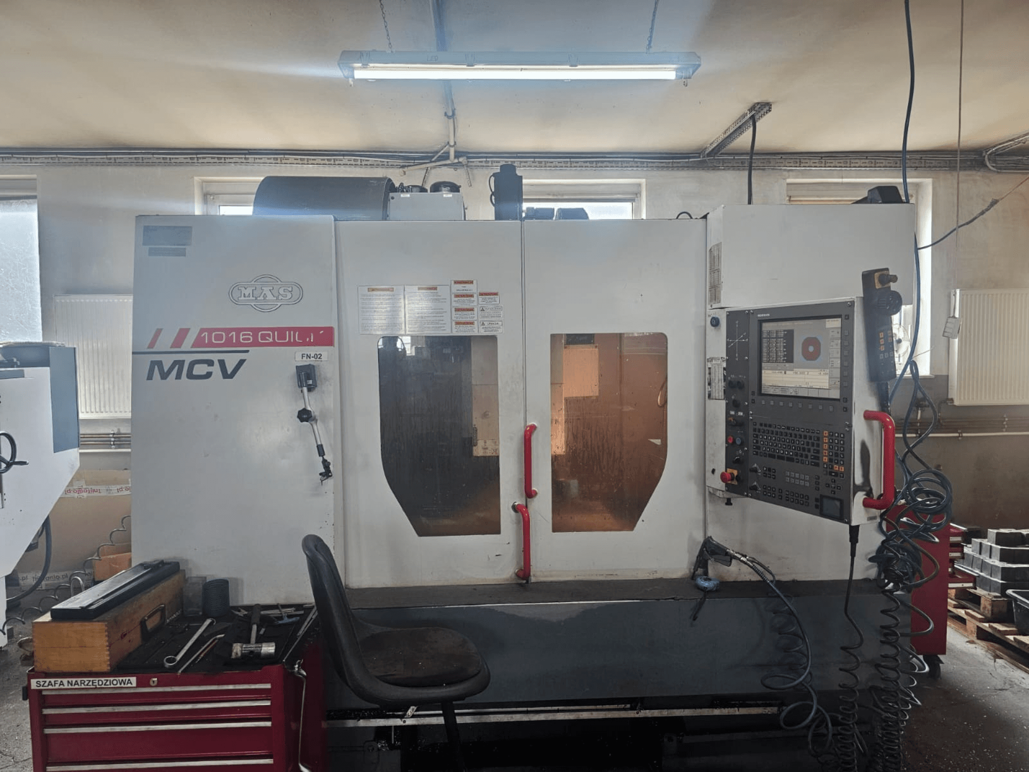 MVS MCV 1016 QUILL CNC machine, front view, featuring control panel, tool drawer, and workspace with tools.