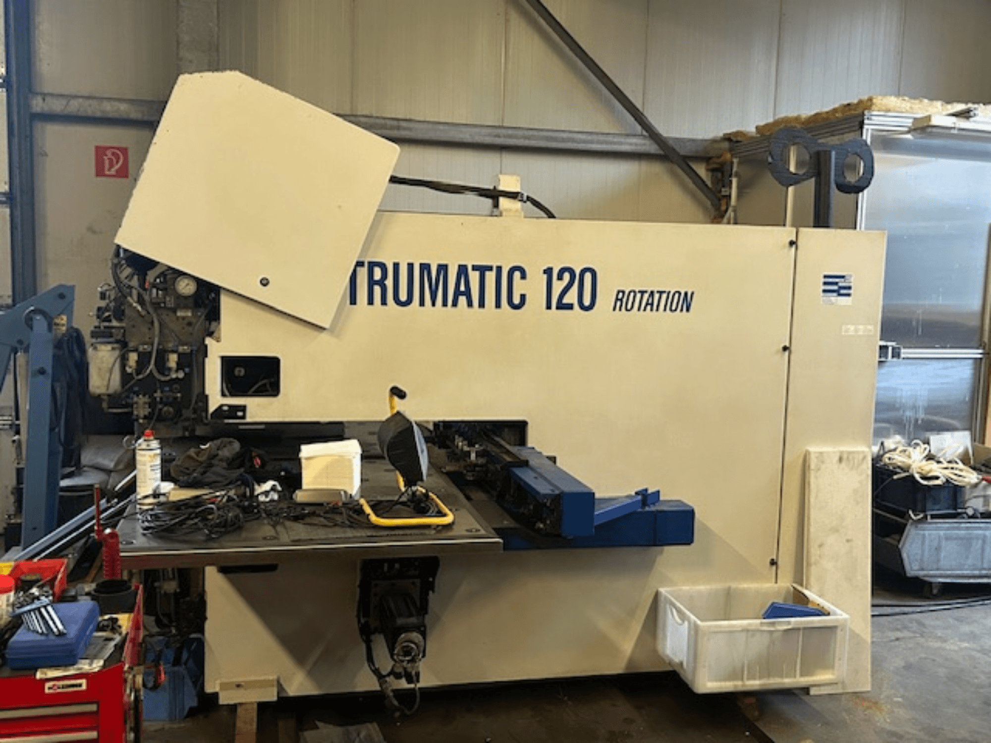 TRUMPF Trumatic 120R CNC punching machine in a workshop, front view showing control panel and tools on the table.