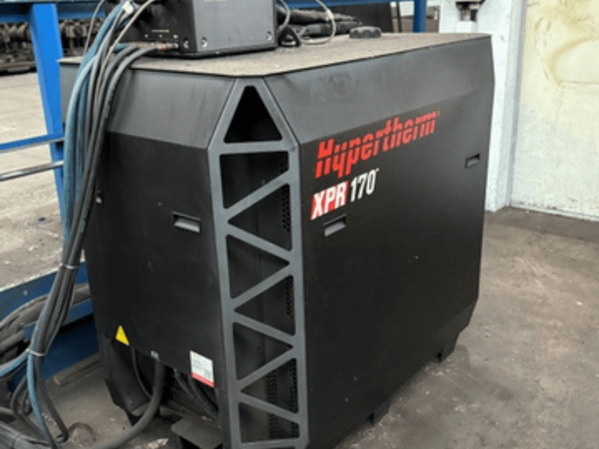 Hypertherm XPR170 plasma cutter, viewed from the side, featuring cooling vents and multiple cables for operation.