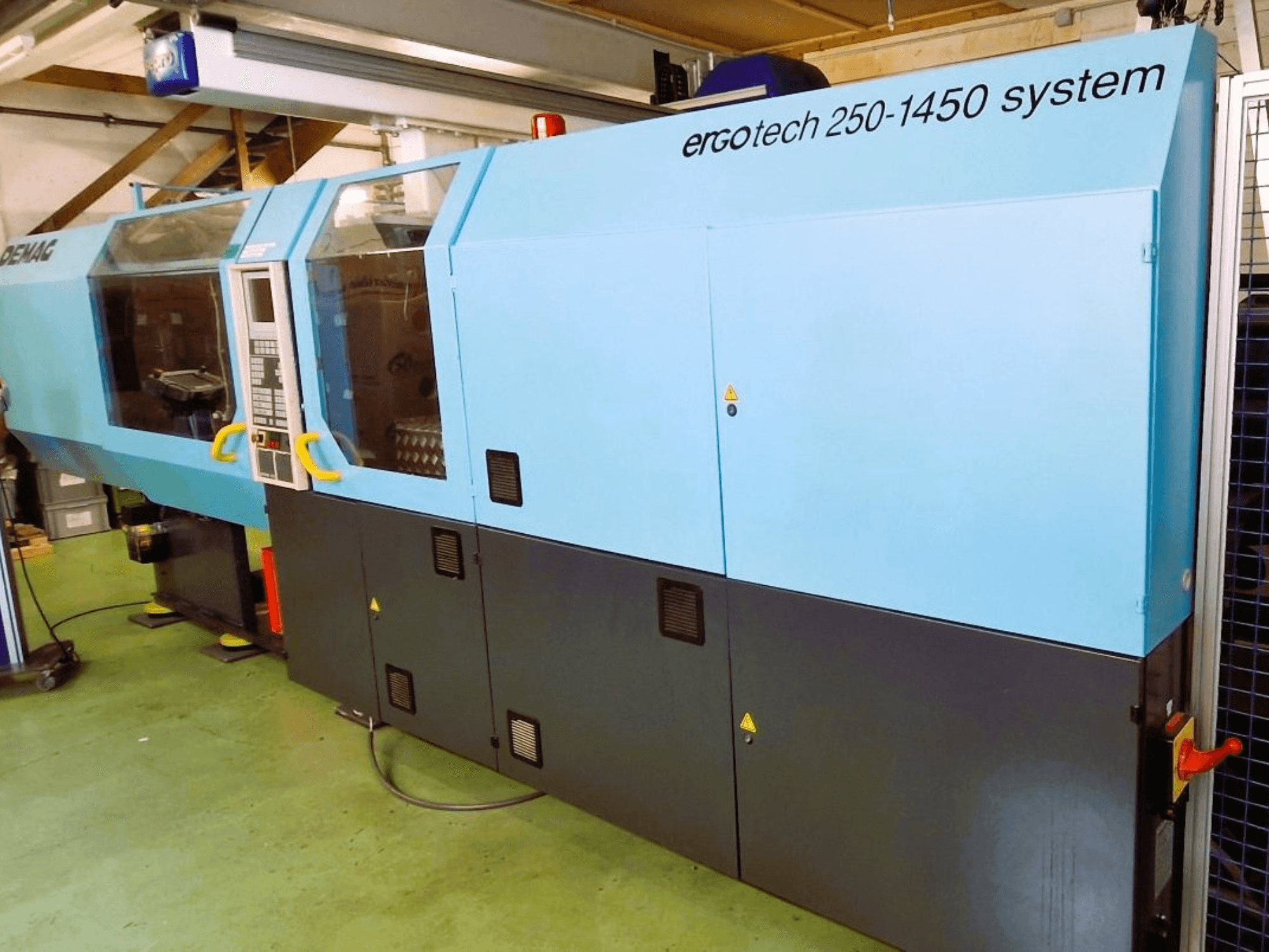 Ergotech 250-1450 system injection molding machine, front view, blue and black color, with control panel and safety features visible.