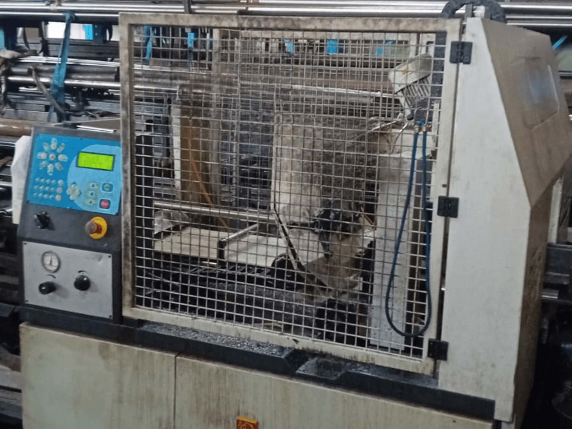 Metal Band Saw Macc 381 AV, front view, showing control panel, safety cage, and metalwork debris on base.