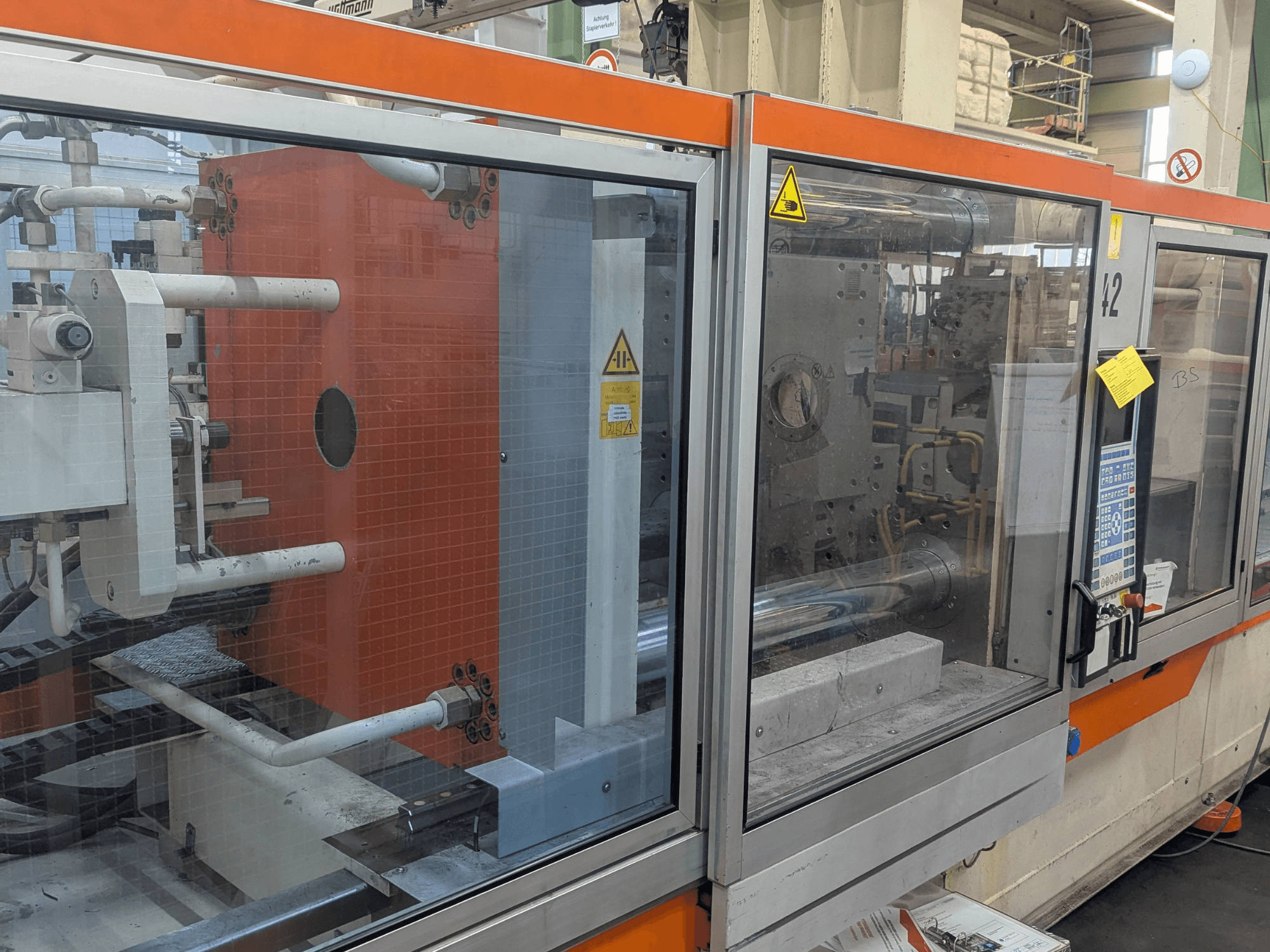 Front view of a DEMAG SYSTEC 80/420-310 hydraulic injection moulding machine with visible control panel and machinery components.