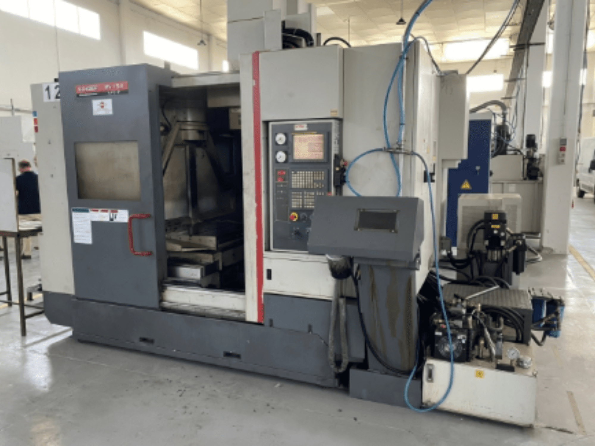 Quaser MV154APC-912 vertical machining center, front view showing control panel, open door, and machine components.