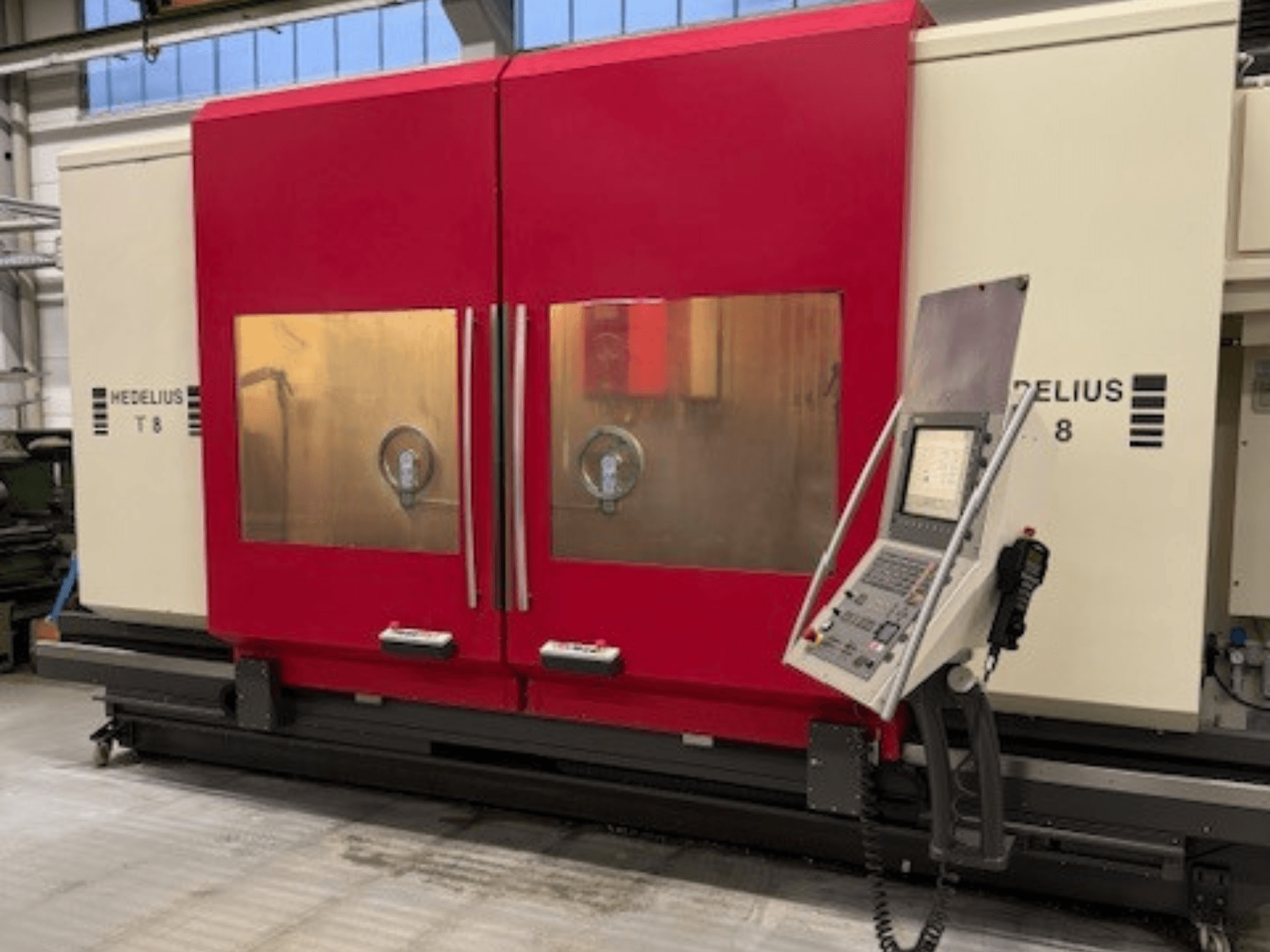 HEDELIUS T8 CNC machine in a front view, featuring red doors, control panel, and visibility of internal components.