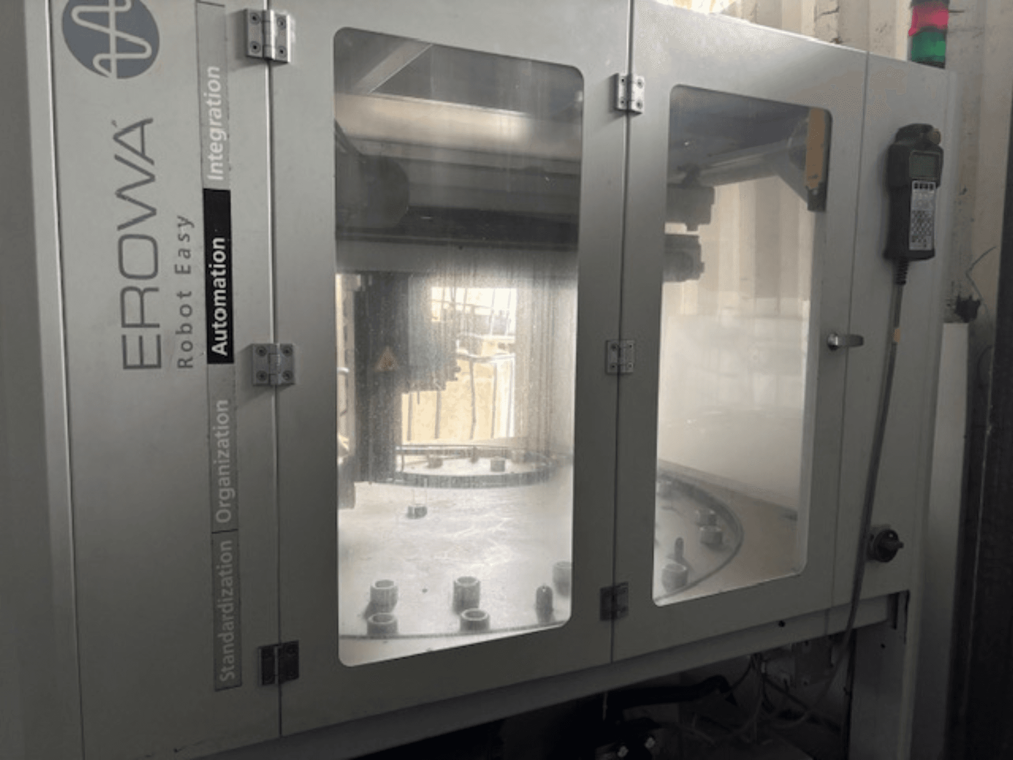 Front view of EROWA Robot Easy Automation; features clear doors, visible automation components, and control panel.