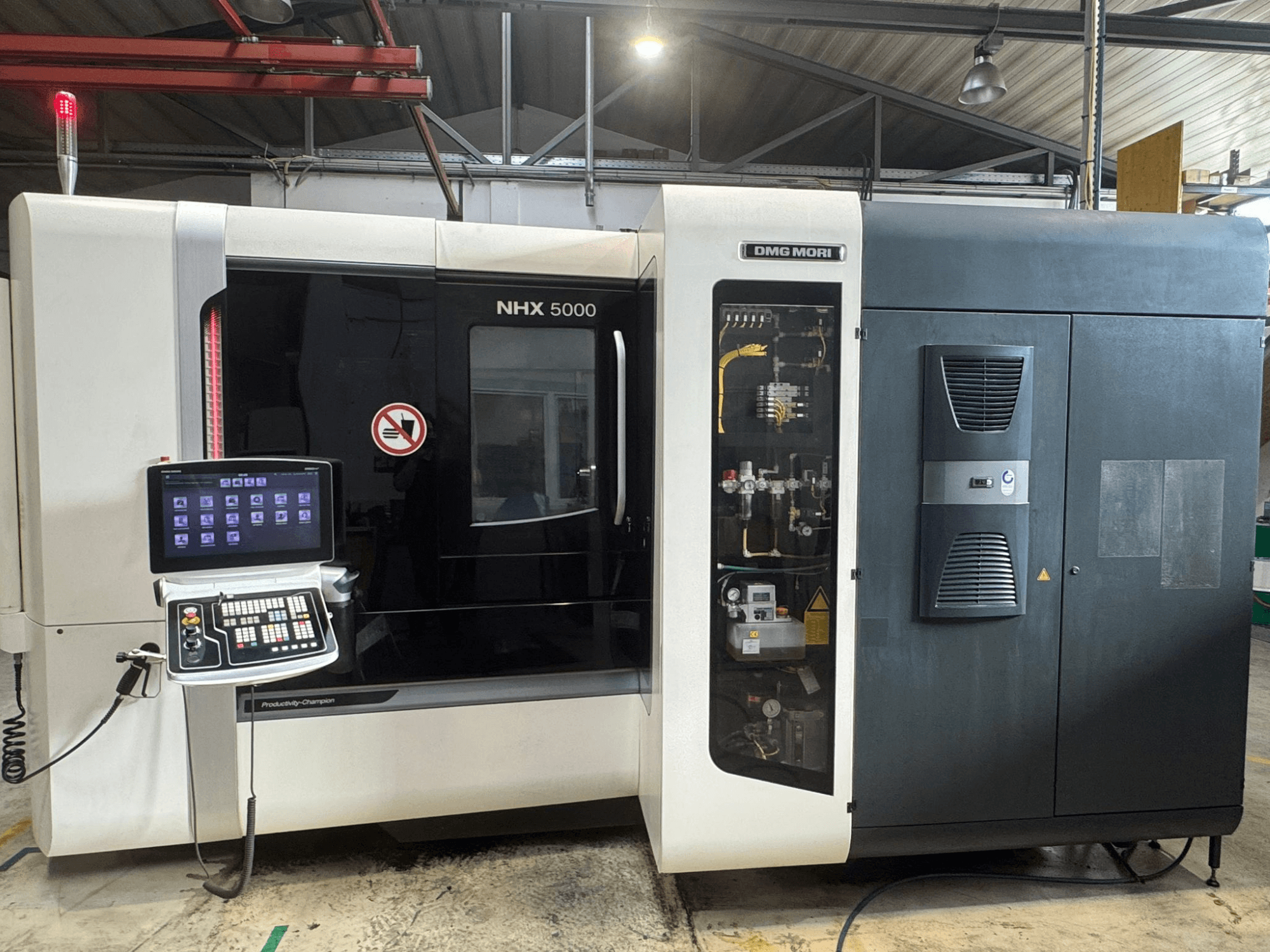 Front view of DMG MORI NHX 5000 horizontal machining center, showcasing the control panel and machine details.