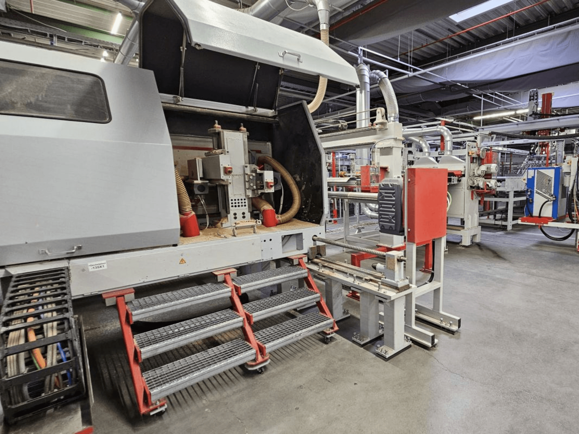 Front view of BURKLE Optima 1428/50 wood production line, featuring steps and visible machinery components.