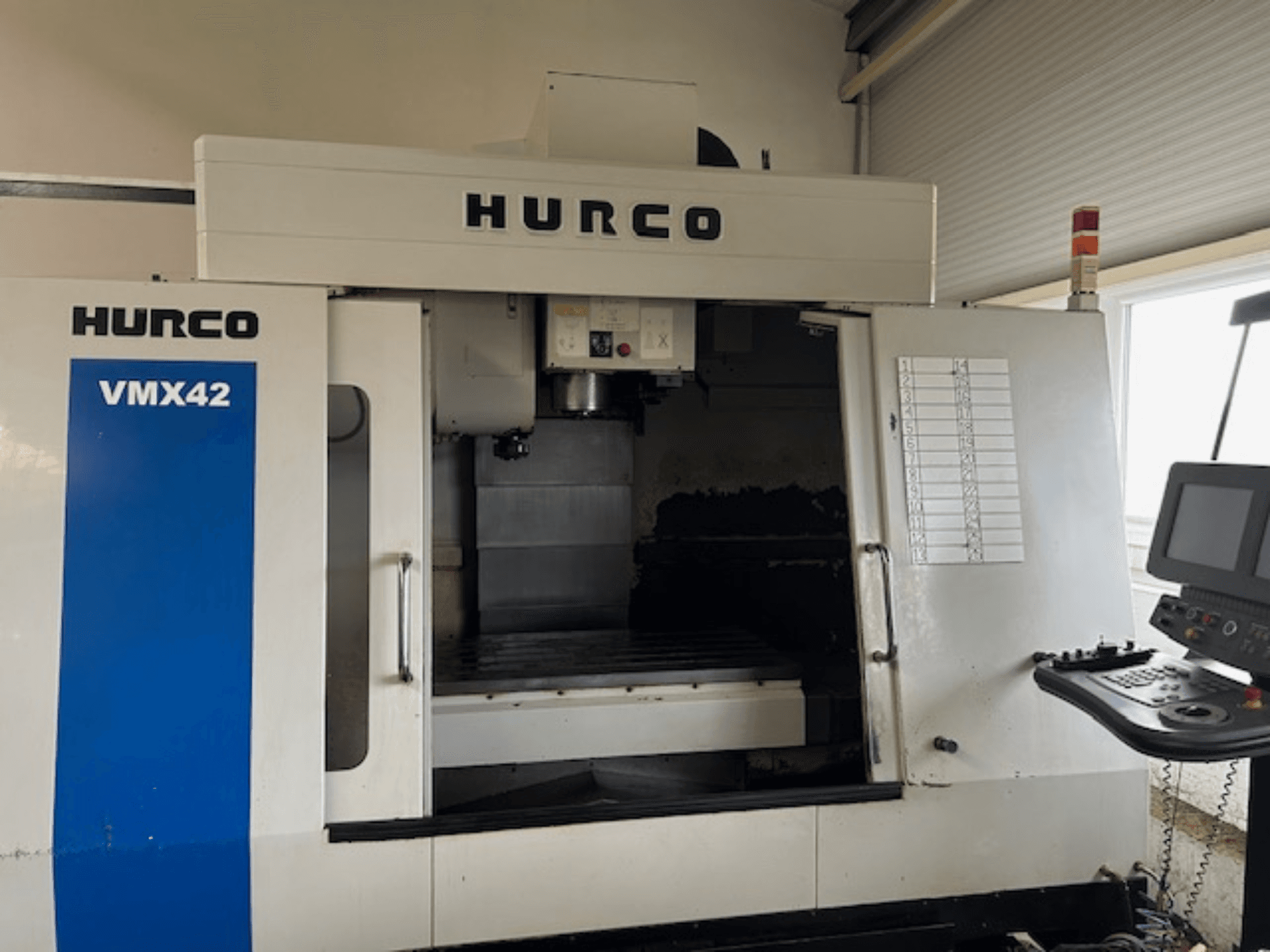Hurco VMX42 CNC machine in front view, showing control panel, spindle, and work area; revealing operational layout.