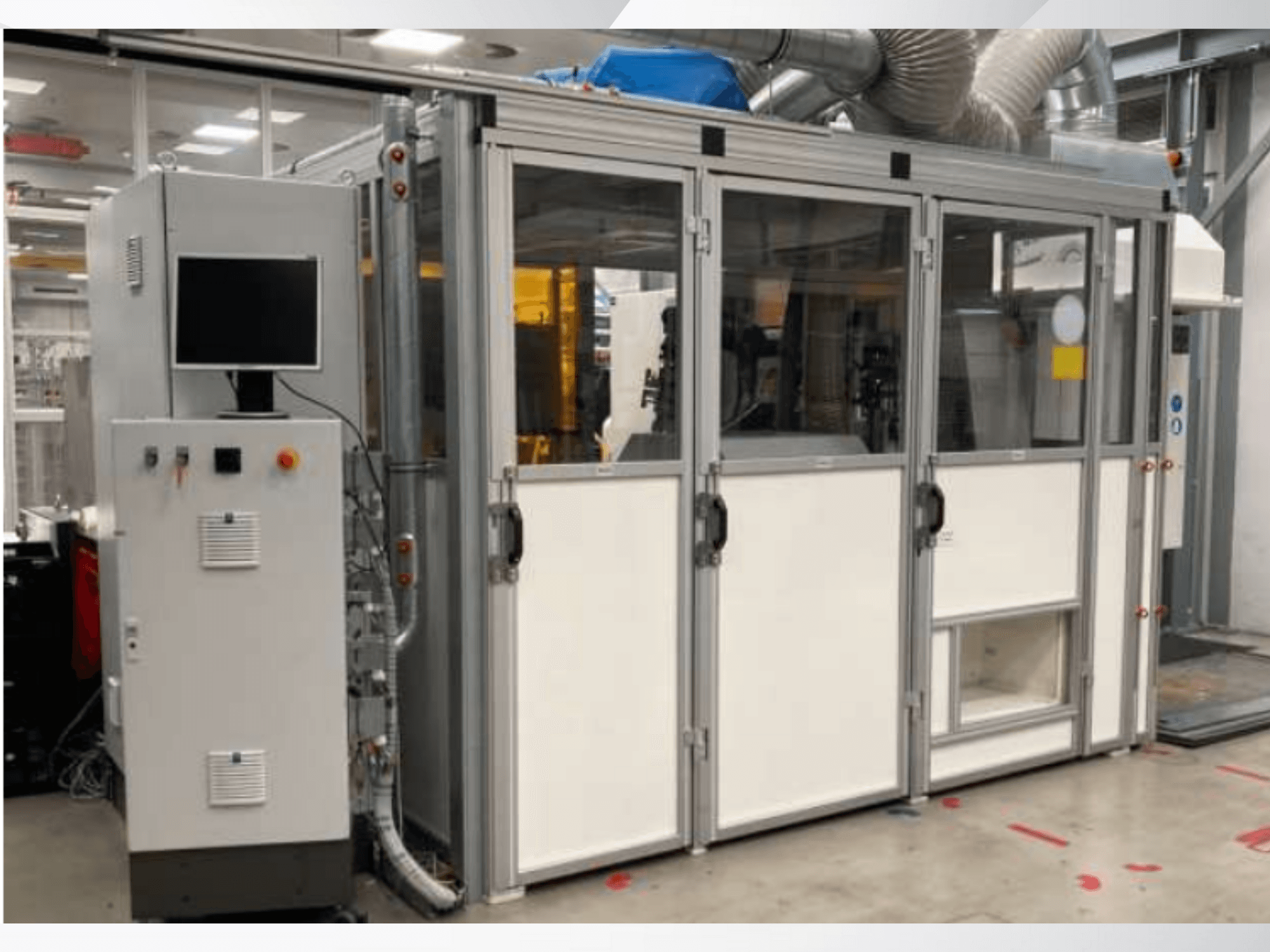 Industrial machine with control panel, front view; features glass doors, ventilation ducts, and visible wiring.