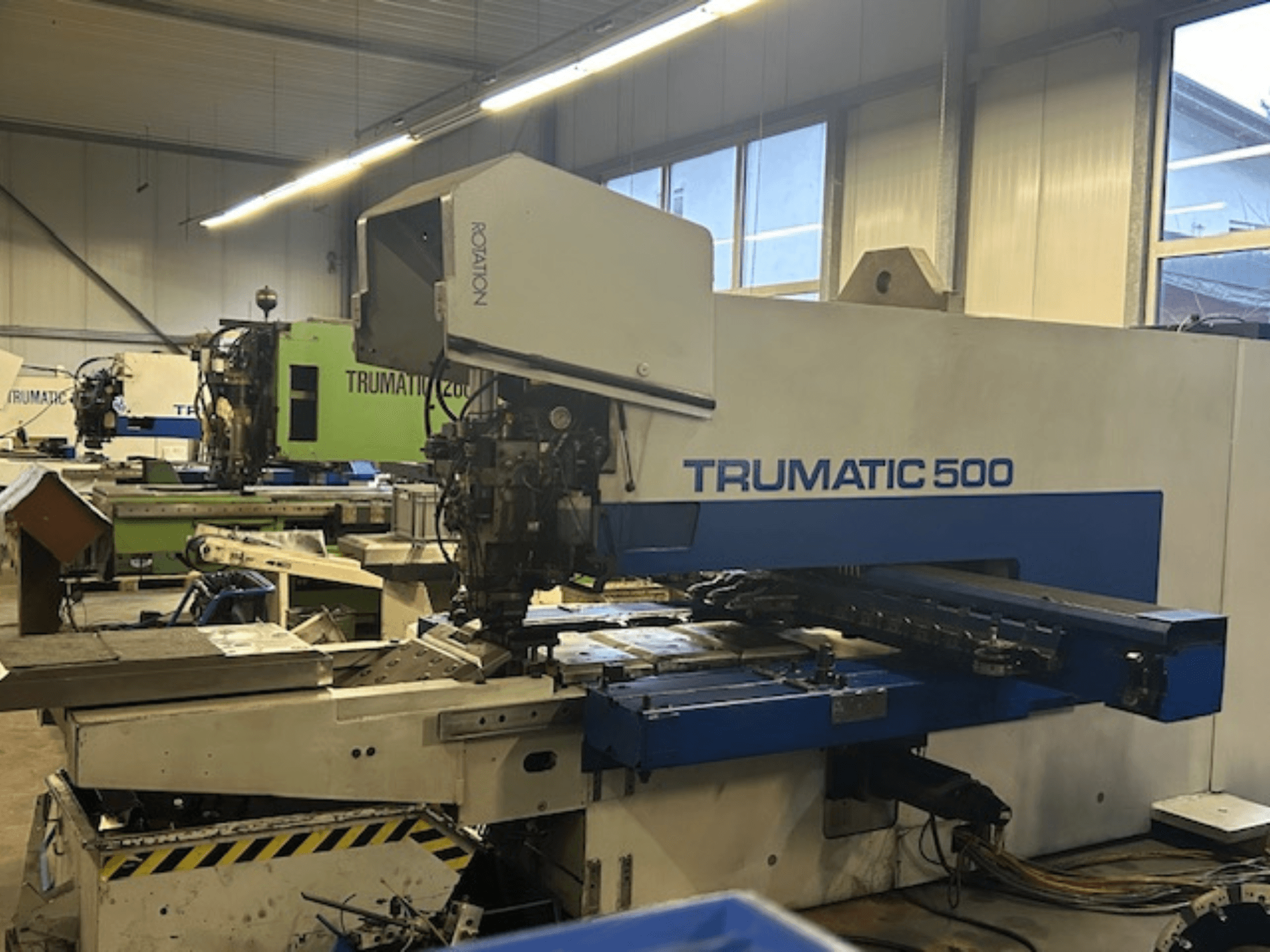TRUMPF TRUMATIC 500 CNC punching machine, front view, featuring control panel and mechanical parts. Industrial workshop setting.