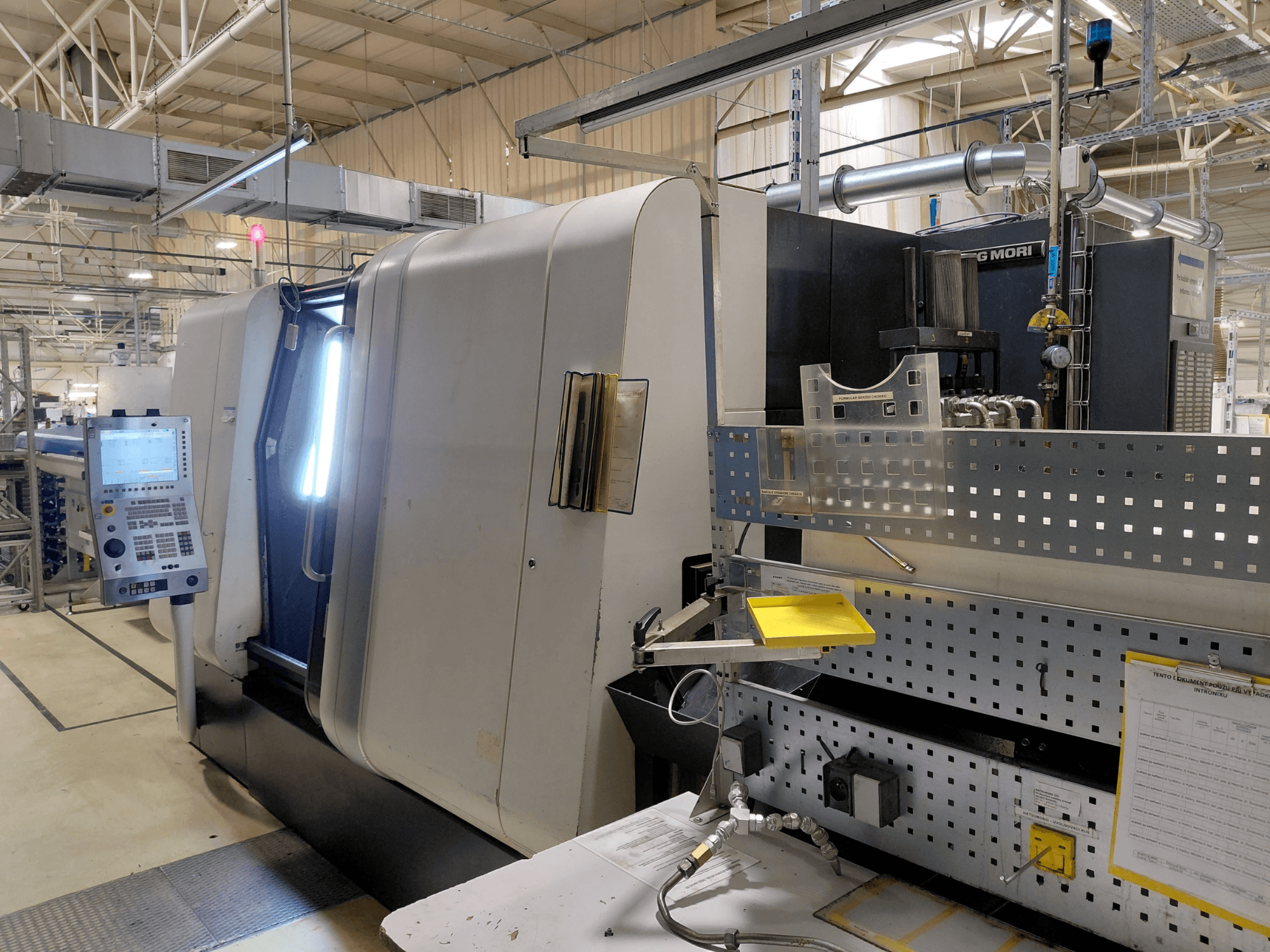 Multi-spindle turning machine DMG MORI Sprint 65 linear, front view, showing control panel and machine features.