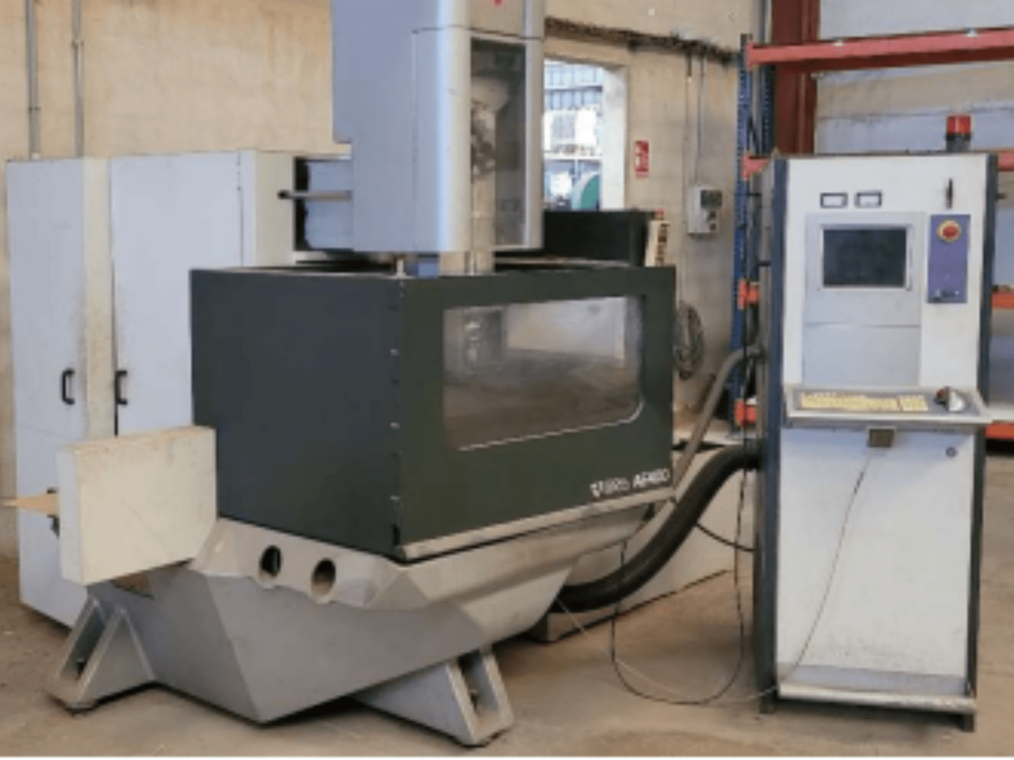 ONA AE 400 Wire EDM machine in a workshop setting, featuring a control panel on the right and a large cutting area.