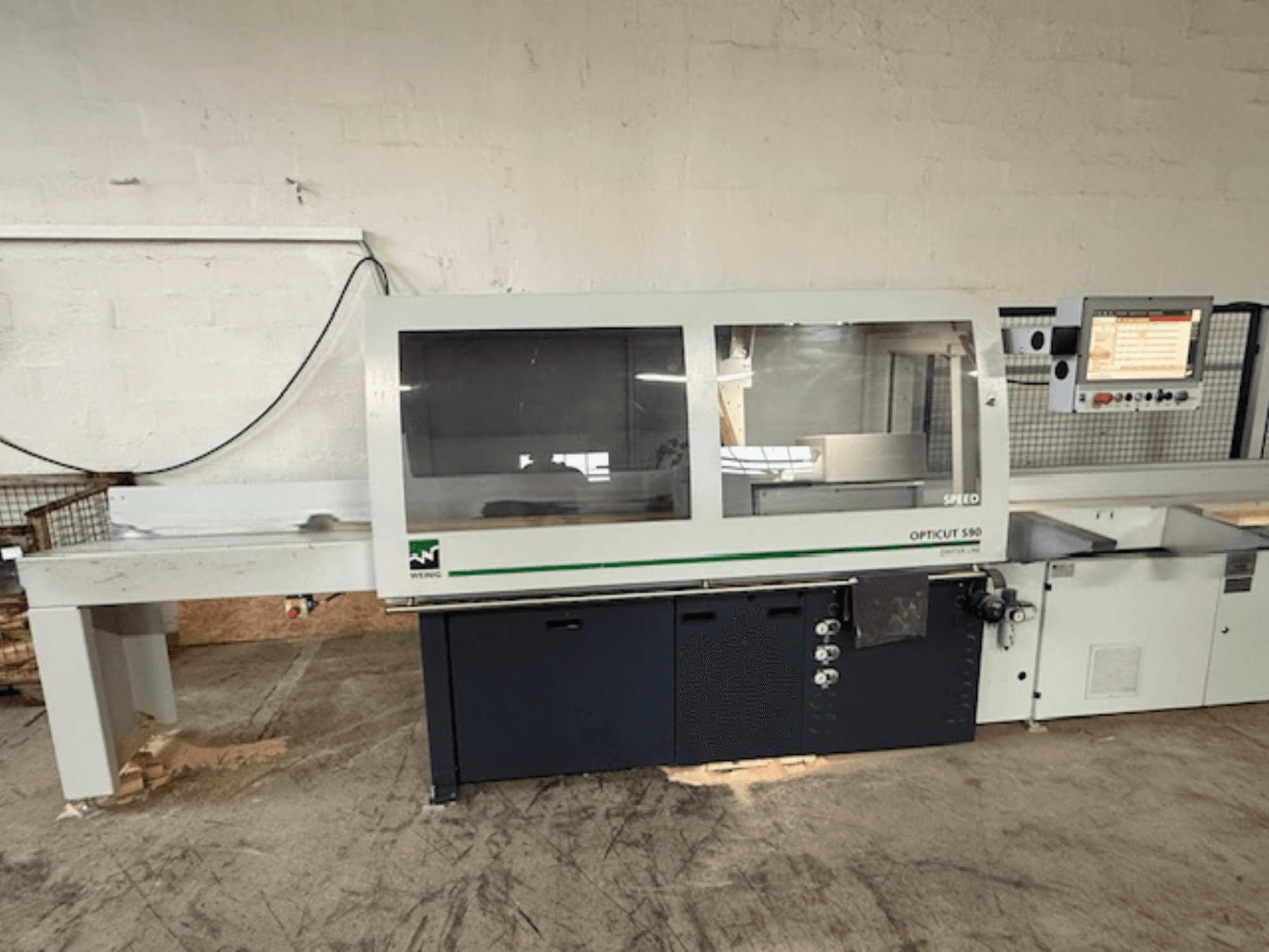 WEINIG OPTICUT S90 optimizing cross-cut saw, front view showing control panel, saw unit, and feed table.