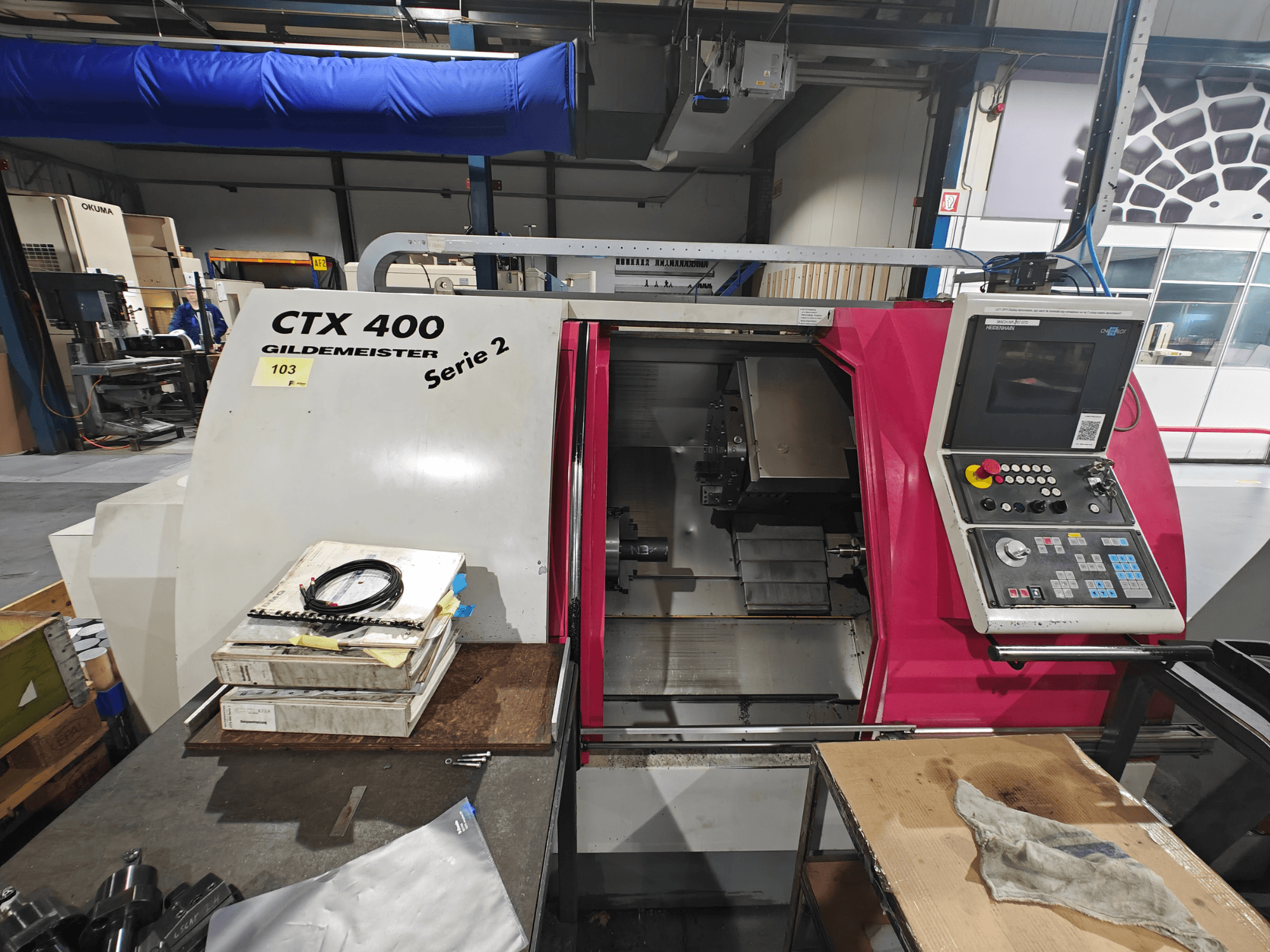 CTX 400 Gildemeister lathe shown from the front, featuring a control panel with buttons, display, and workspace.