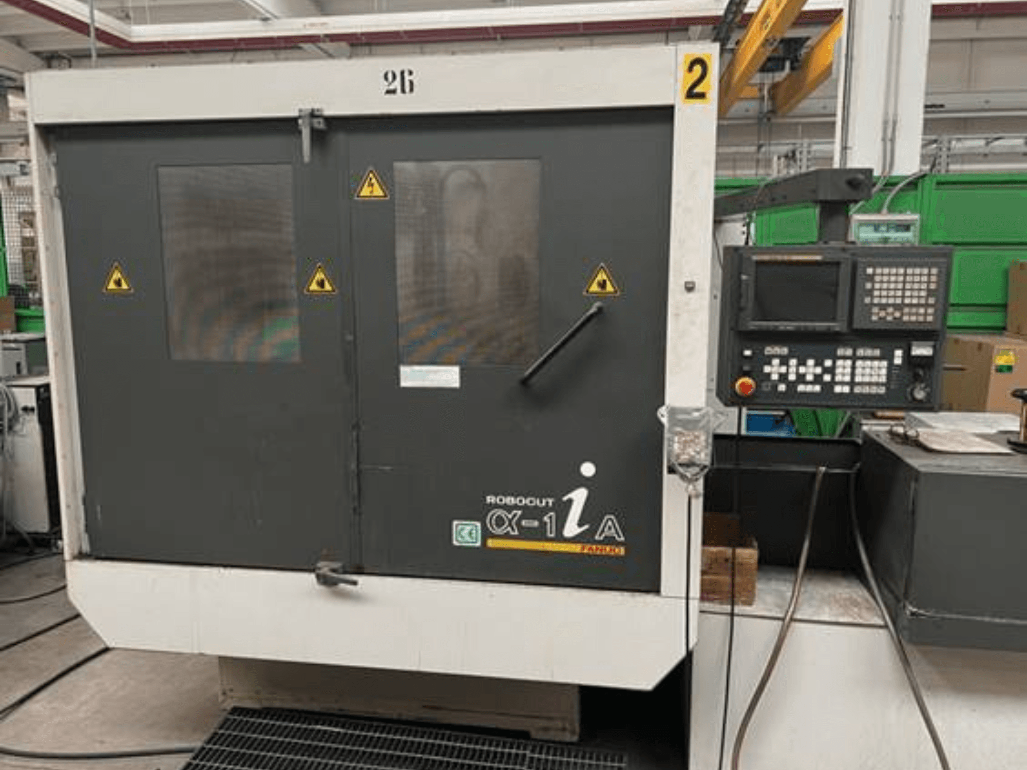 Rodout CX-1A machining center, front view, featuring control panel, safety warnings, and enclosed work area with glass windows.