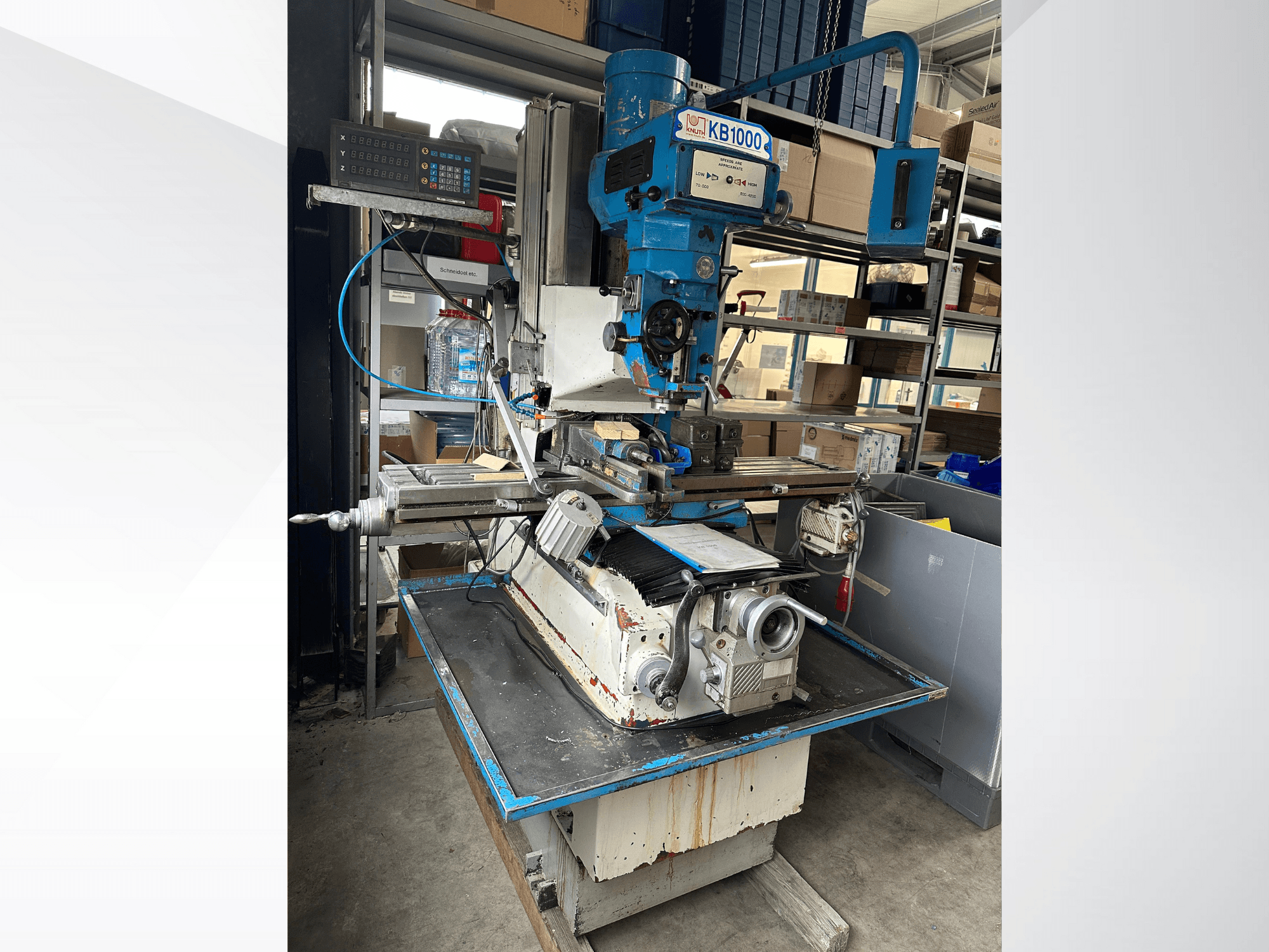 Vertical milling machine KB1000 with digital display, side view showcasing the table, spindle, and tool holder.