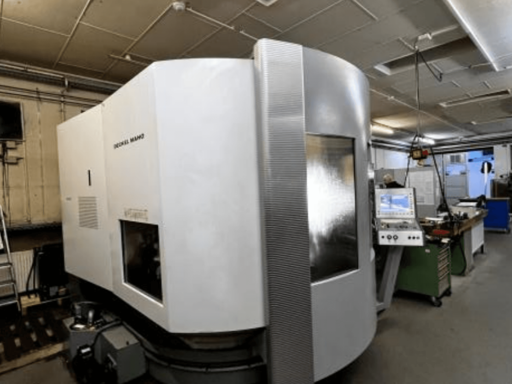 SODICK MAKO CNC machine in a workshop, side view, with control panel and work area visible in background.