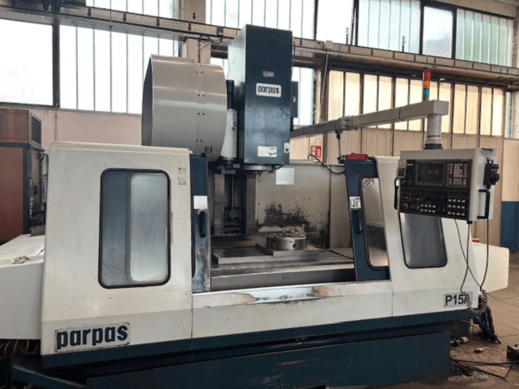 Parpas P15 A vertical machining centre in a workshop, showcasing control panel and spindle from a side view.