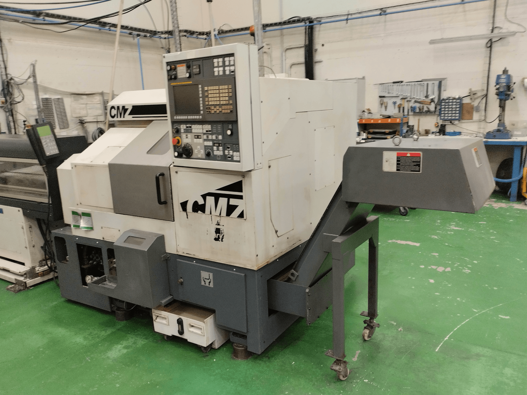 CMZ TB-67M Turn-Mill Centre in front view, featuring control panel and feeding mechanism, set in a workshop environment.