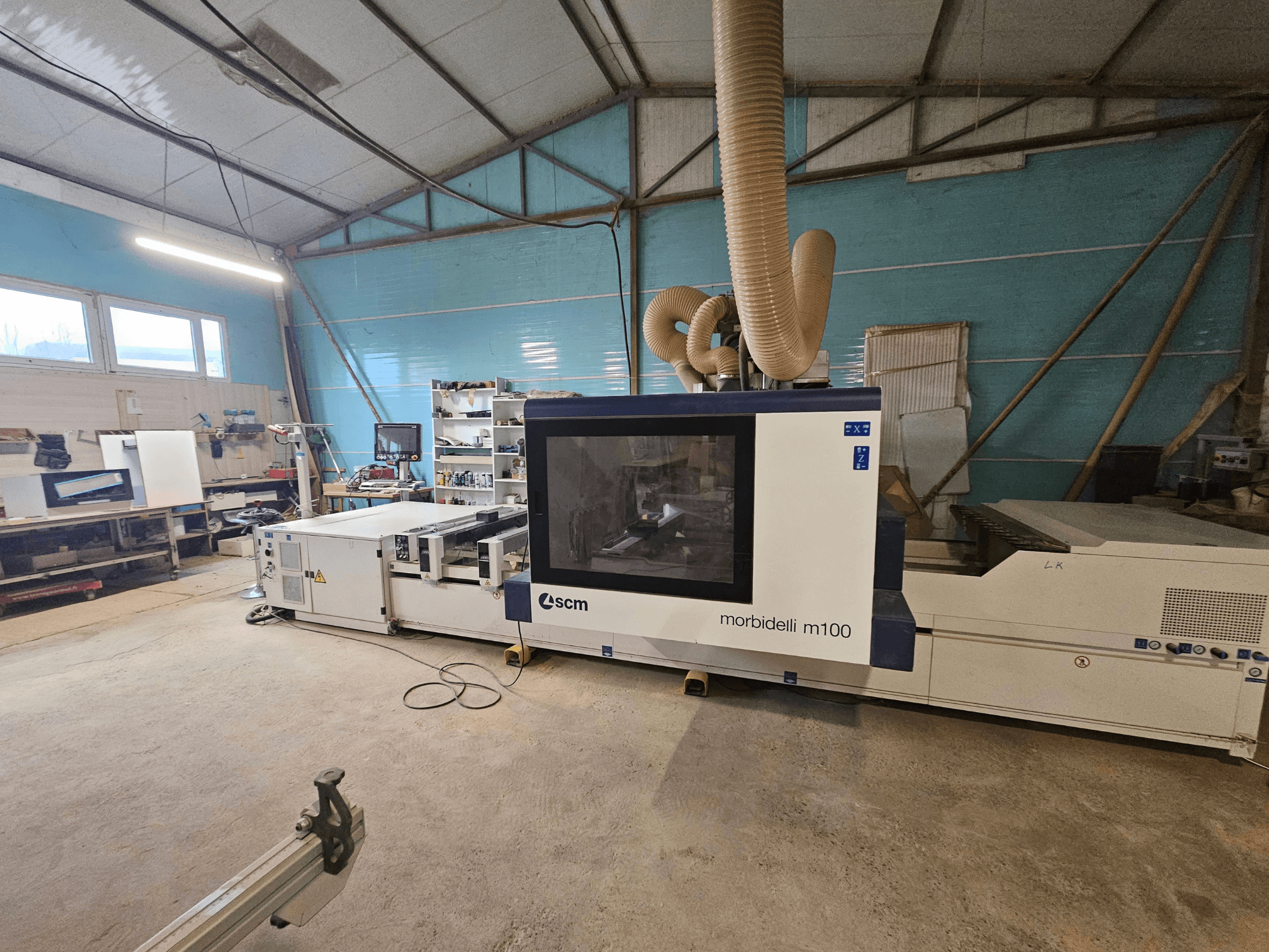SCM Morbidelli M100 CNC machine in a workshop, front view, showcasing dust extraction system and control panel.