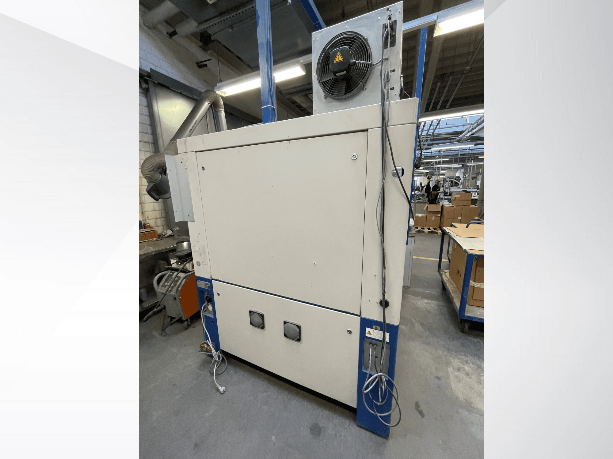 Industrial drying machine with fan, side view; features ventilation and multiple electrical connections. Brand/model not visible.